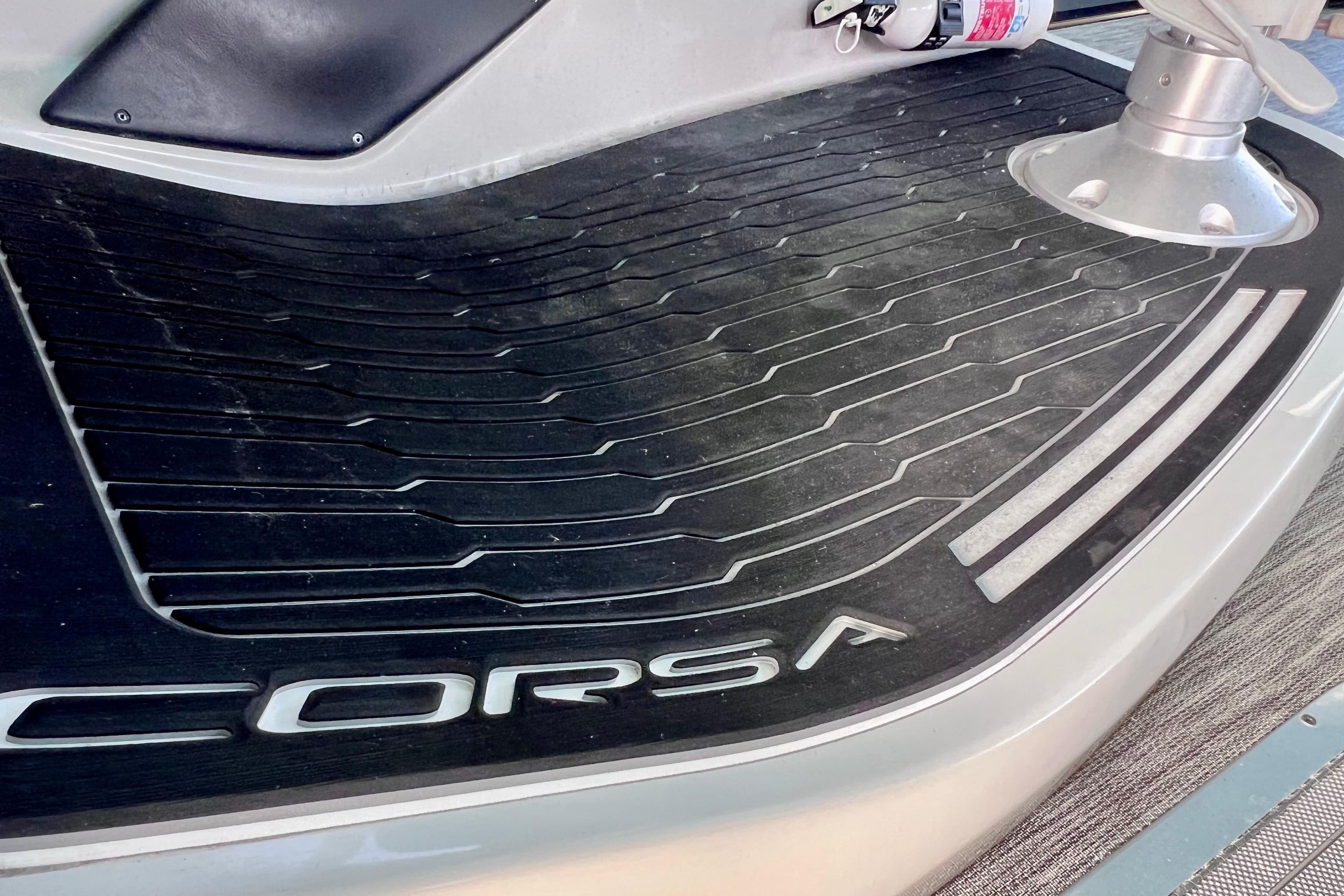 2023 Barletta Corsa 23UC boat deck with logo and textured surface.