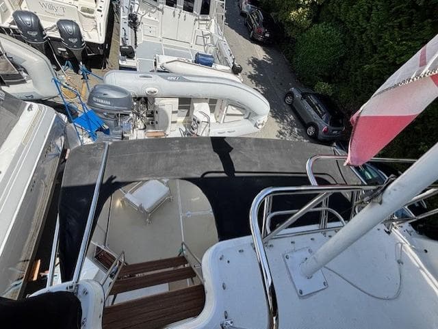 1988 Riviera Convertible yacht docked among other boats, view from upper deck.