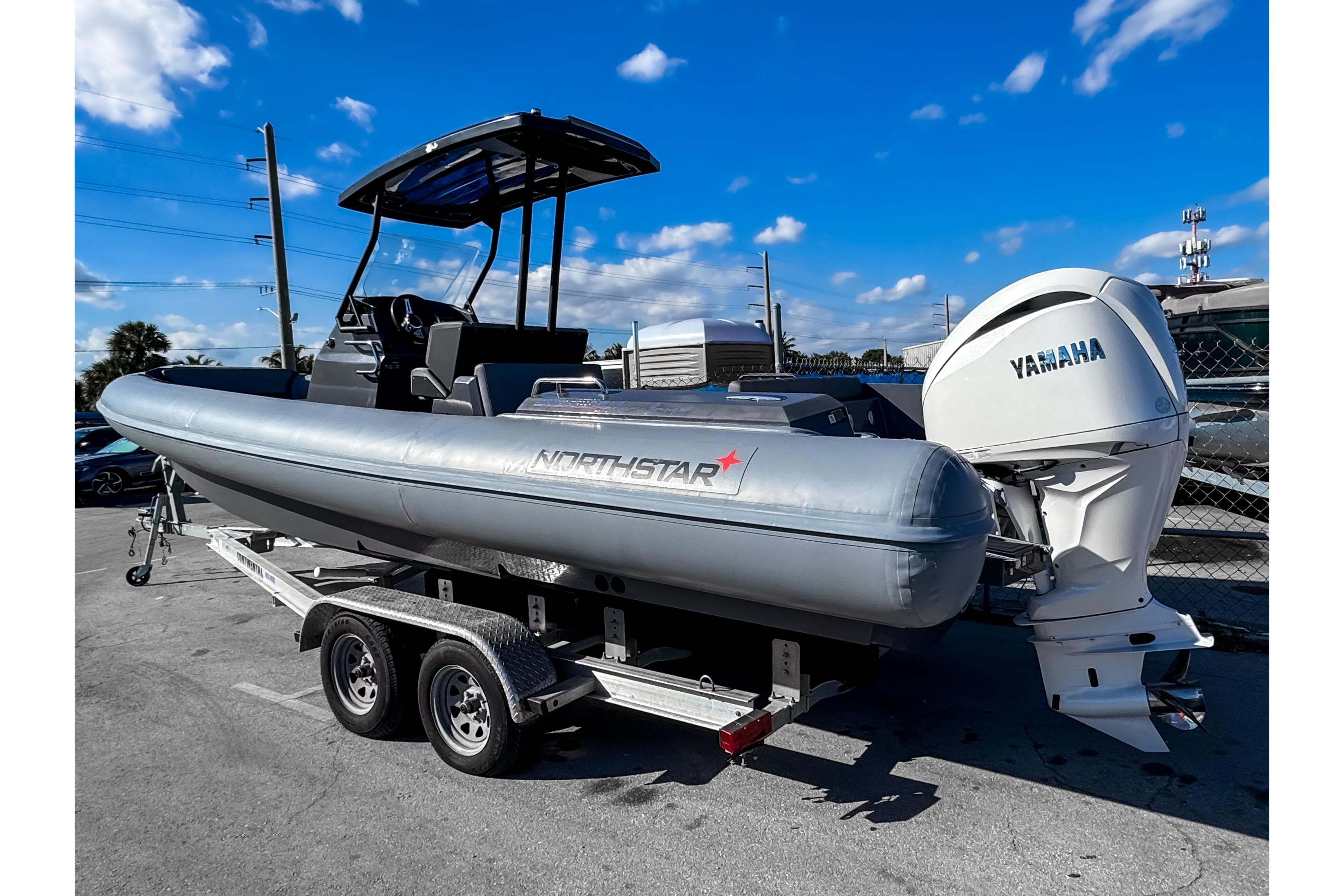 2024 Northstar Orion 8 boat on trailer with Yamaha engine, under clear blue sky.