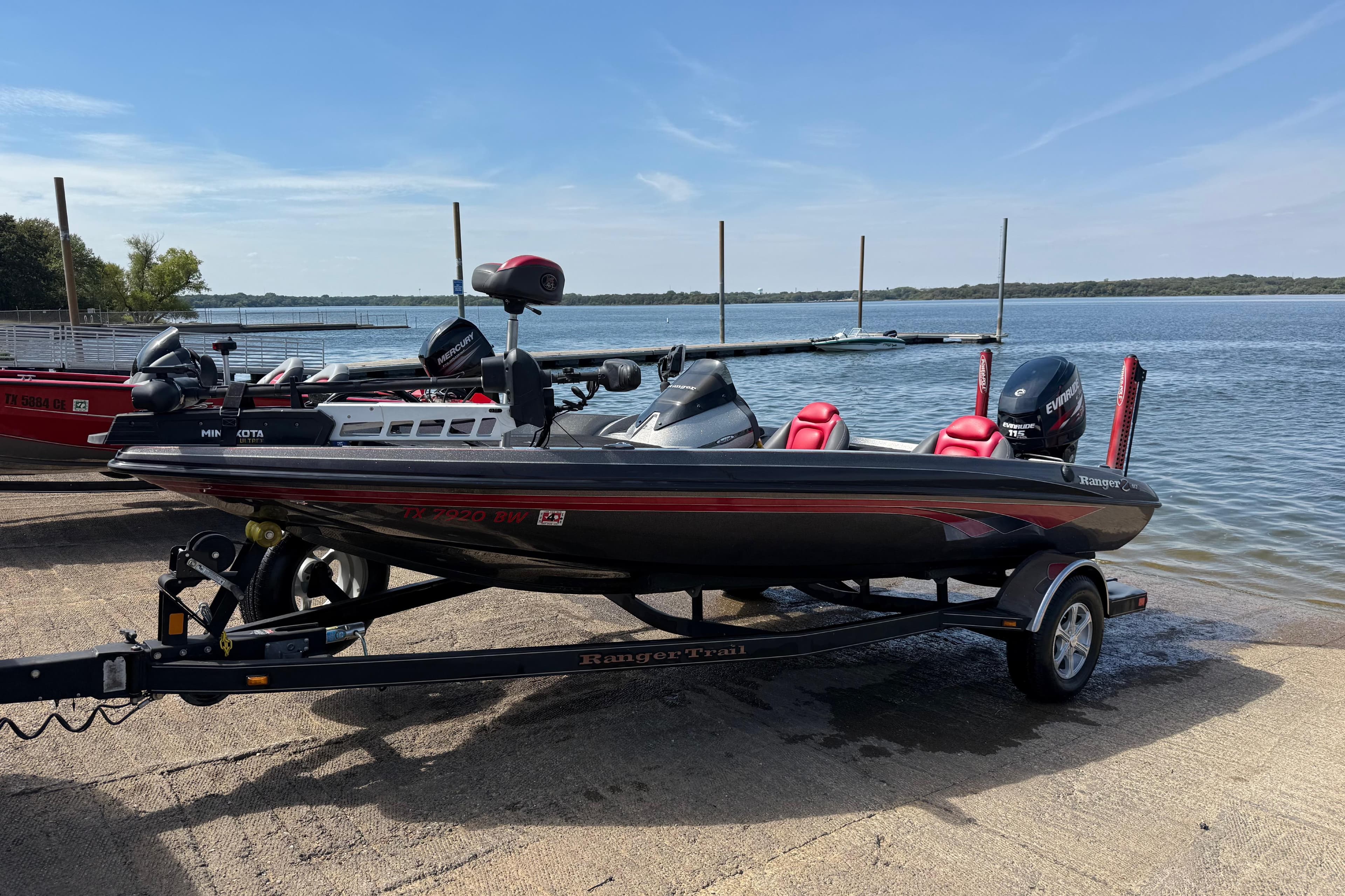 2013 Ranger Z117 boat on trailer by a lake, ready for launch.