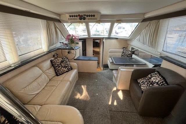 Luxurious interior of a 1999 Carver 404 Cockpit Motor Yacht with plush seating and elegant decor.