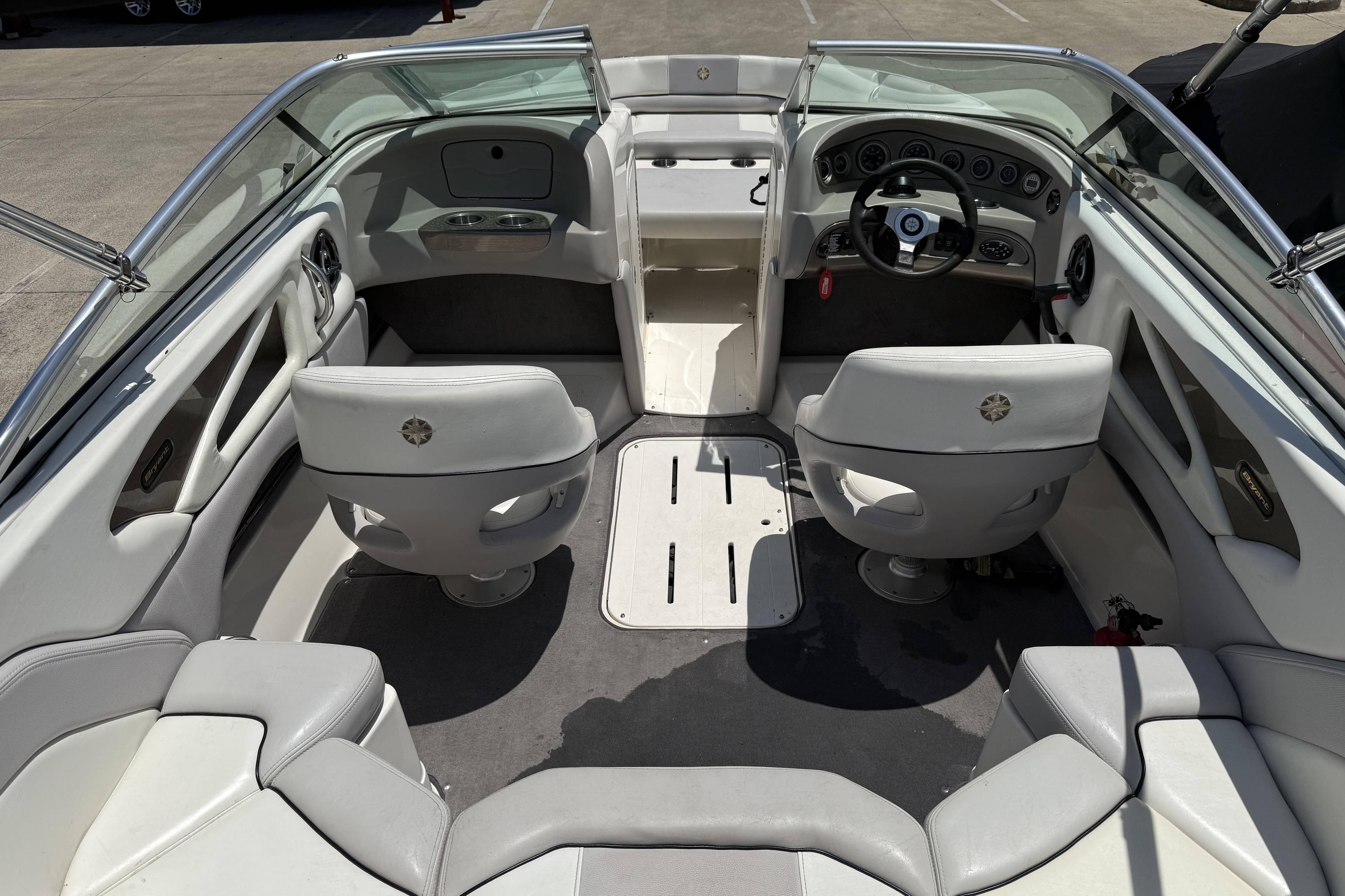 Interior of a 2010 Bryant 233 boat with seating and steering wheel.