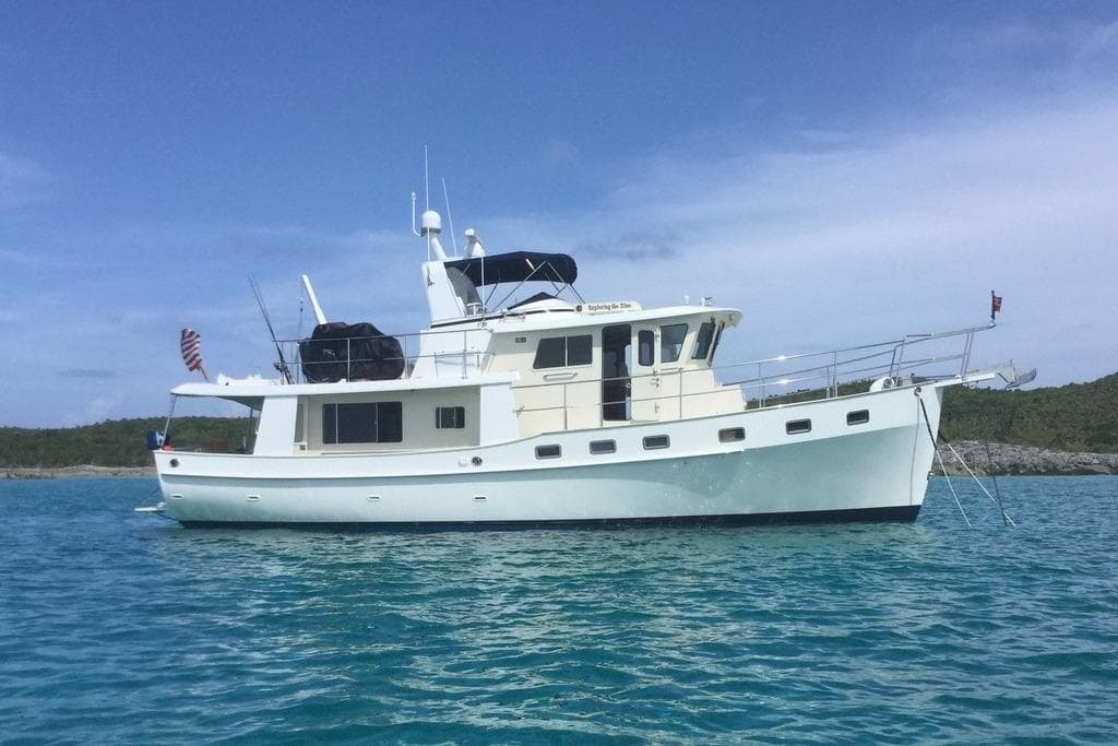 2011 Kadey-Krogen 48 AE yacht anchored in clear blue water.