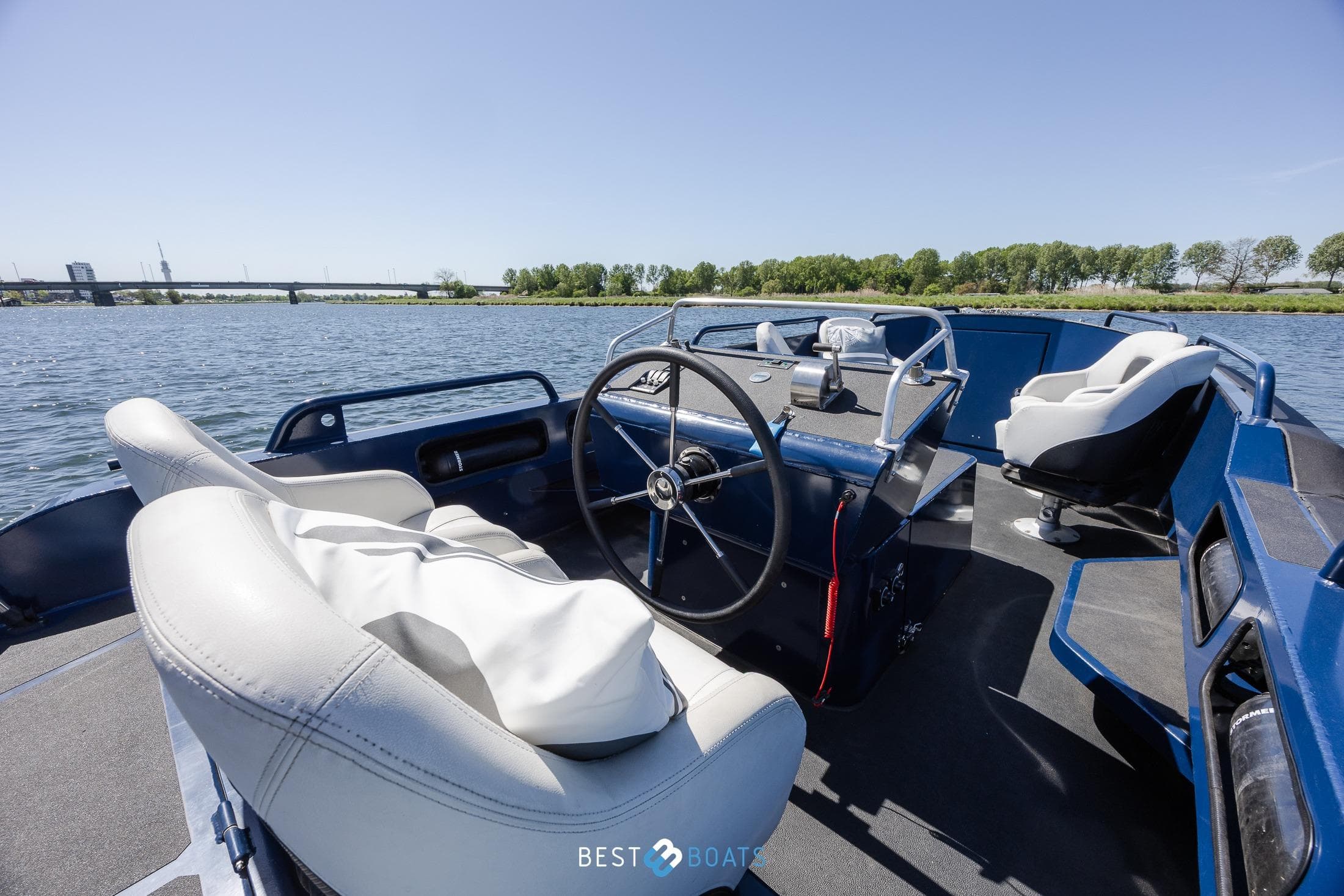 2018 Stormer Marine Tender R75 boat interior with steering wheel on a sunny day.