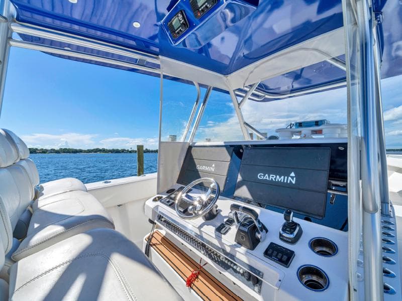 SeaHunter 45 2015 boat cockpit with Garmin navigation system and blue canopy.