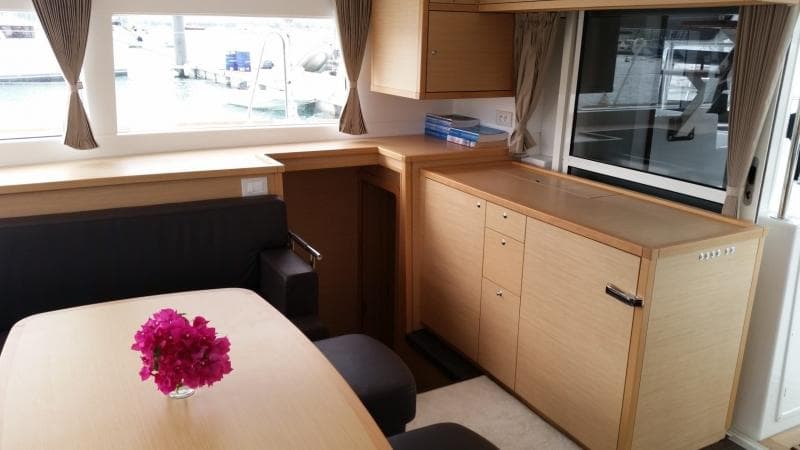 Interior of 2017 Lagoon 450S yacht with modern furnishings and floral centerpiece.