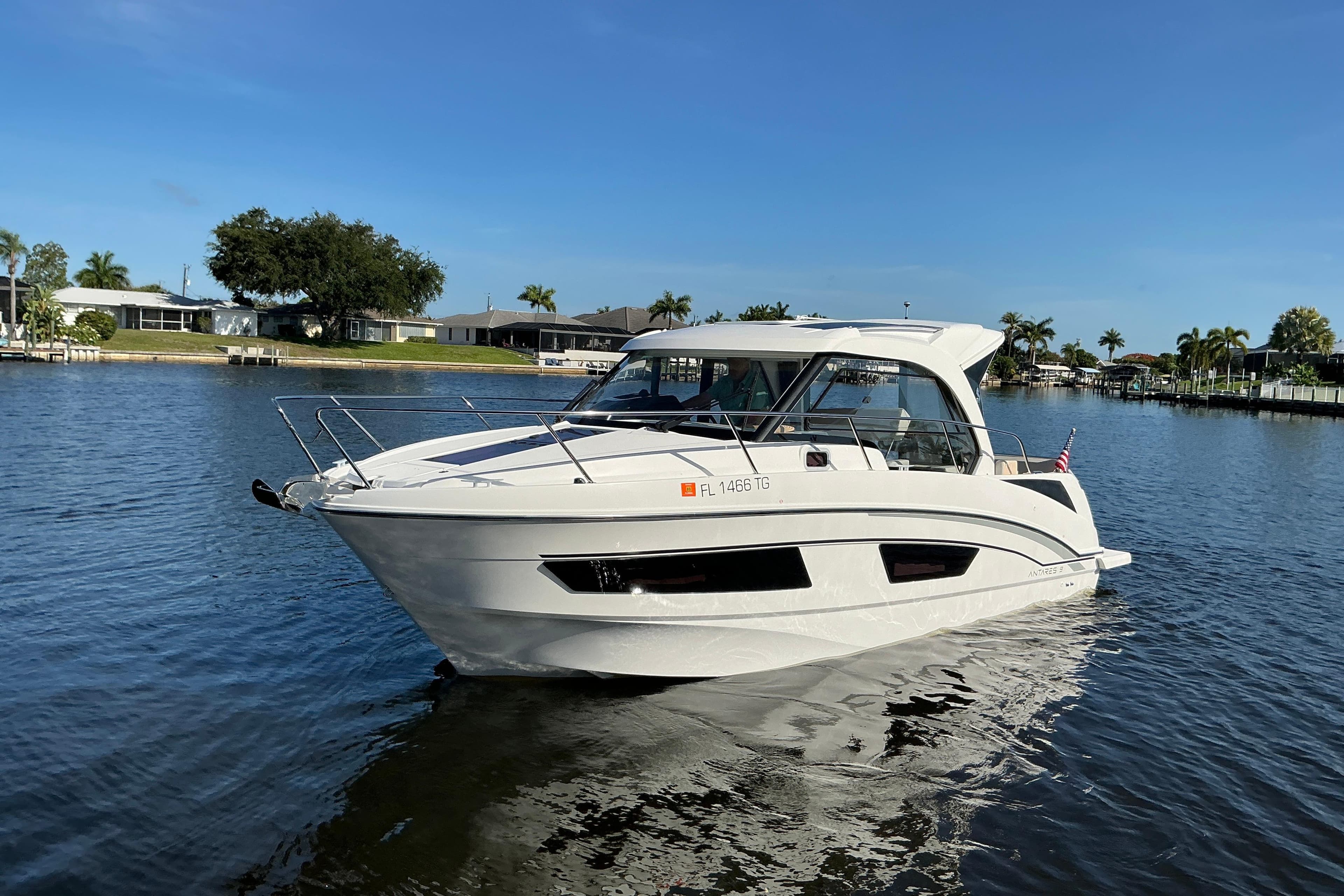 2022 Beneteau Antares 9 boat cruising on a sunny day in a calm waterway.