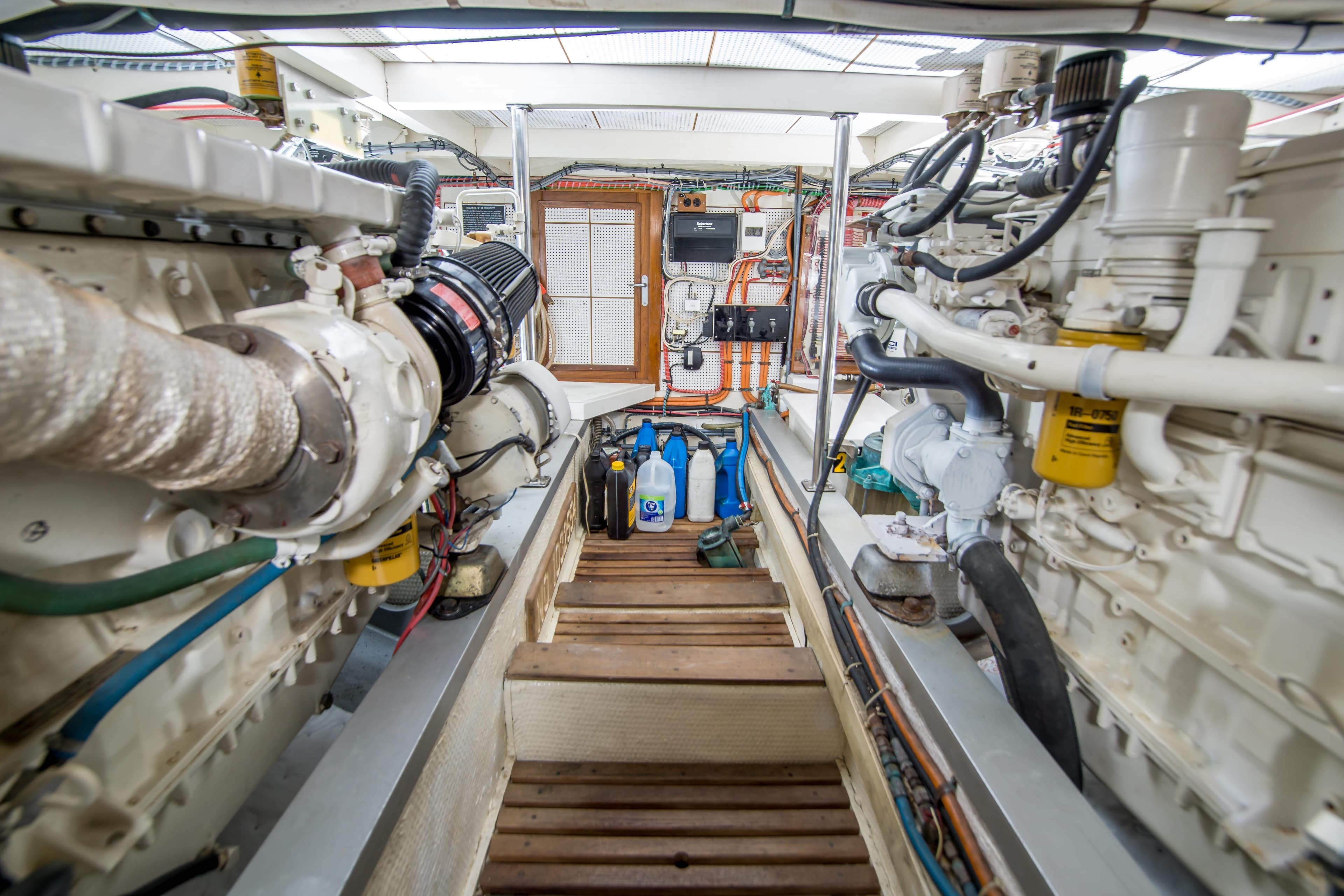 Engine room of a 1995 Grand Banks 42 Classic yacht, showcasing dual engines and equipment.