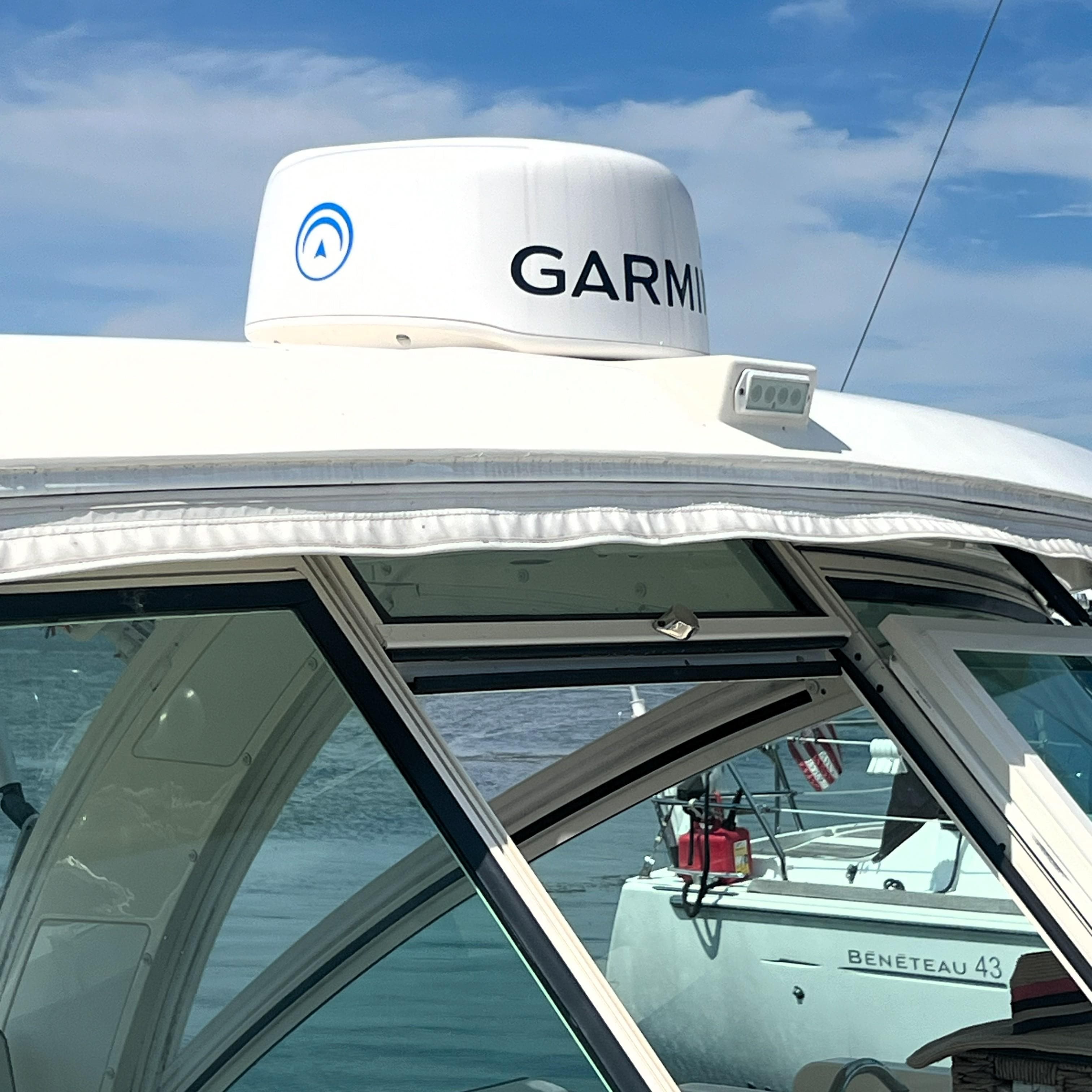 2016 World Cat 320 DC boat with Garmin radar, docked near a Beneteau 43.