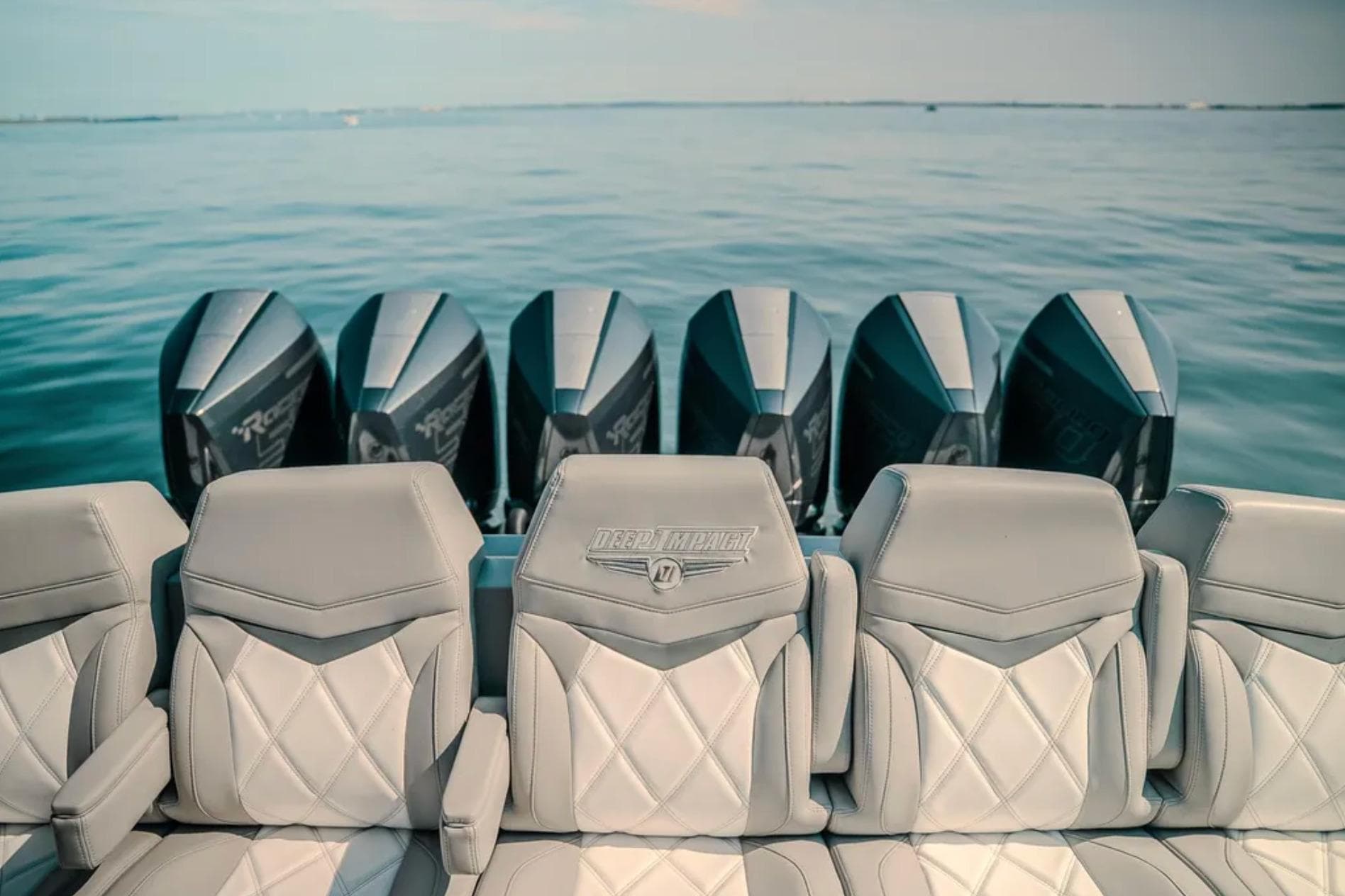 2026 Deep Impact 499 Sport boat with multiple powerful outboard engines on calm water.