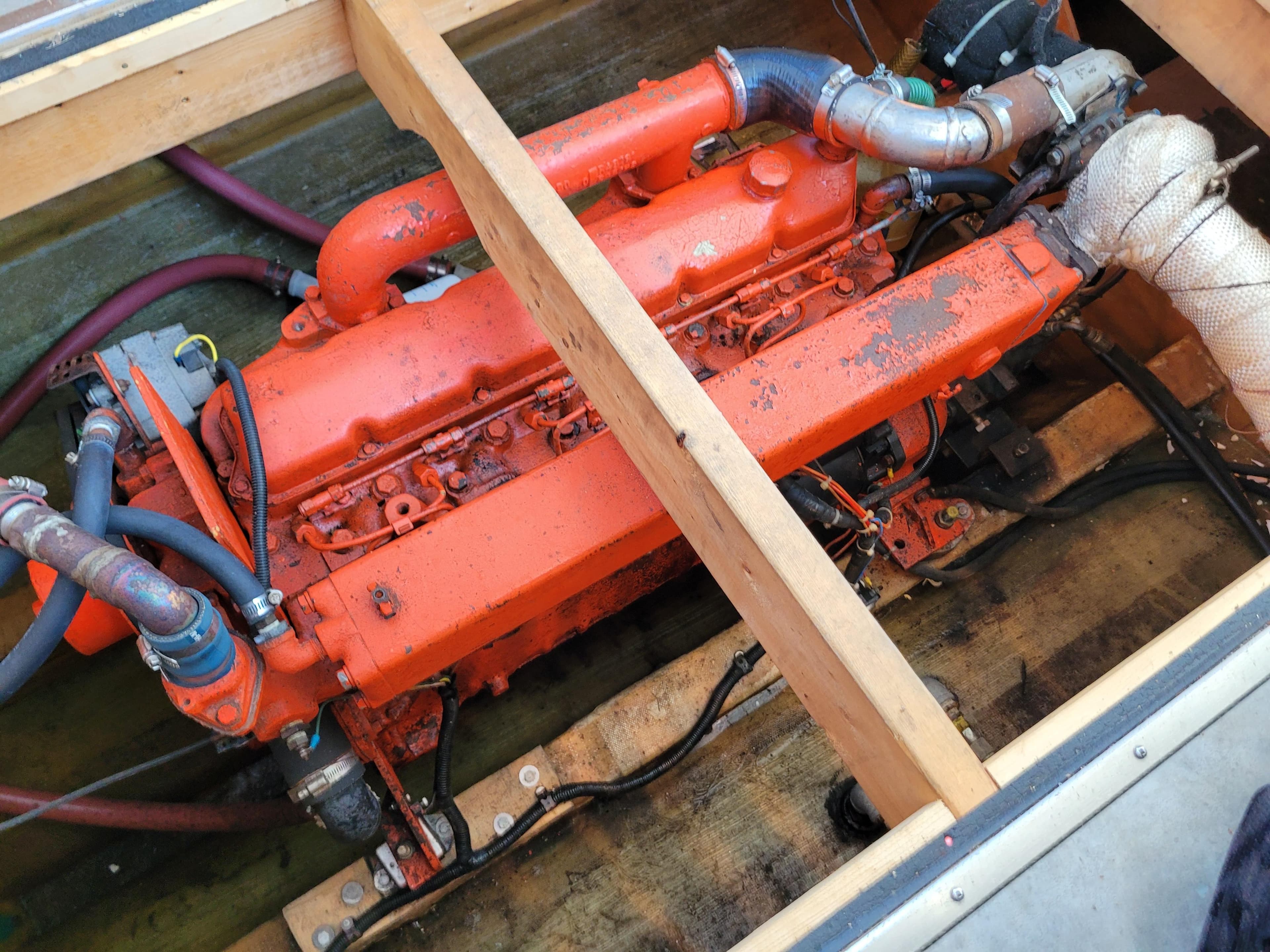 Orange engine of a 2009 Deschamp & Jackson Cape Island 32 boat, partially exposed.