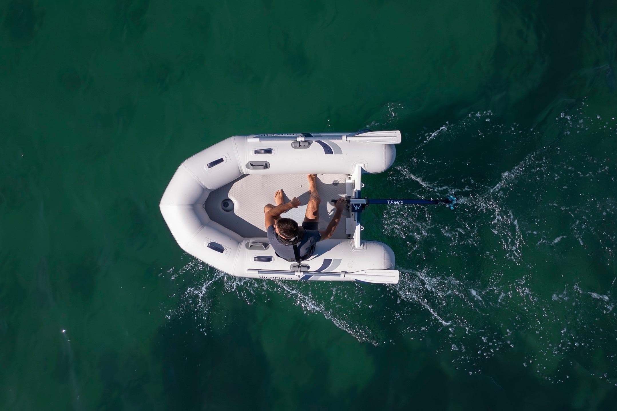 Aerial view of Highfield Roll-Up 250 KAL boat on water.