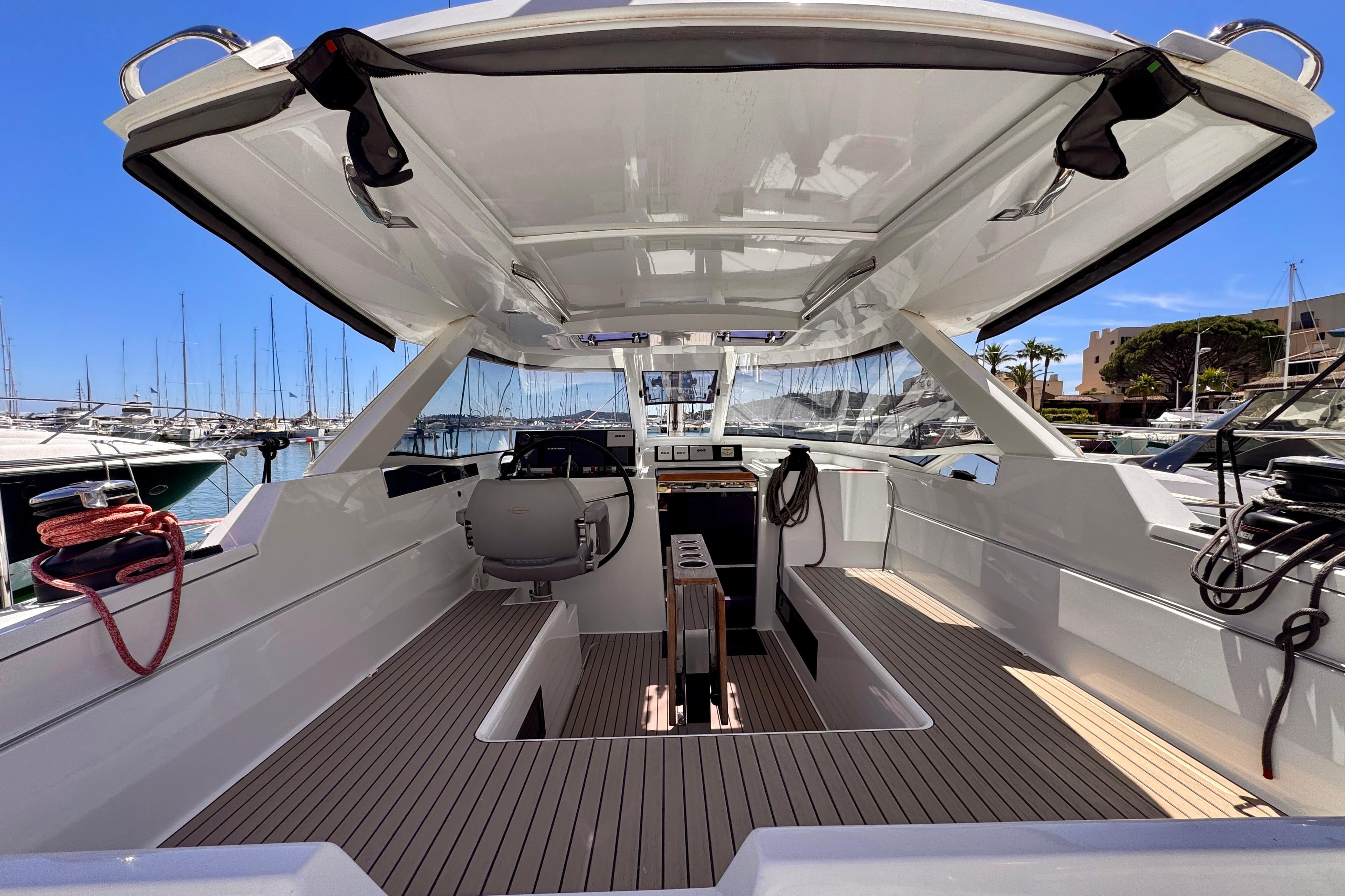 Modern 2017 Amel 50 yacht interior with sleek design, docked at a marina under clear blue skies.