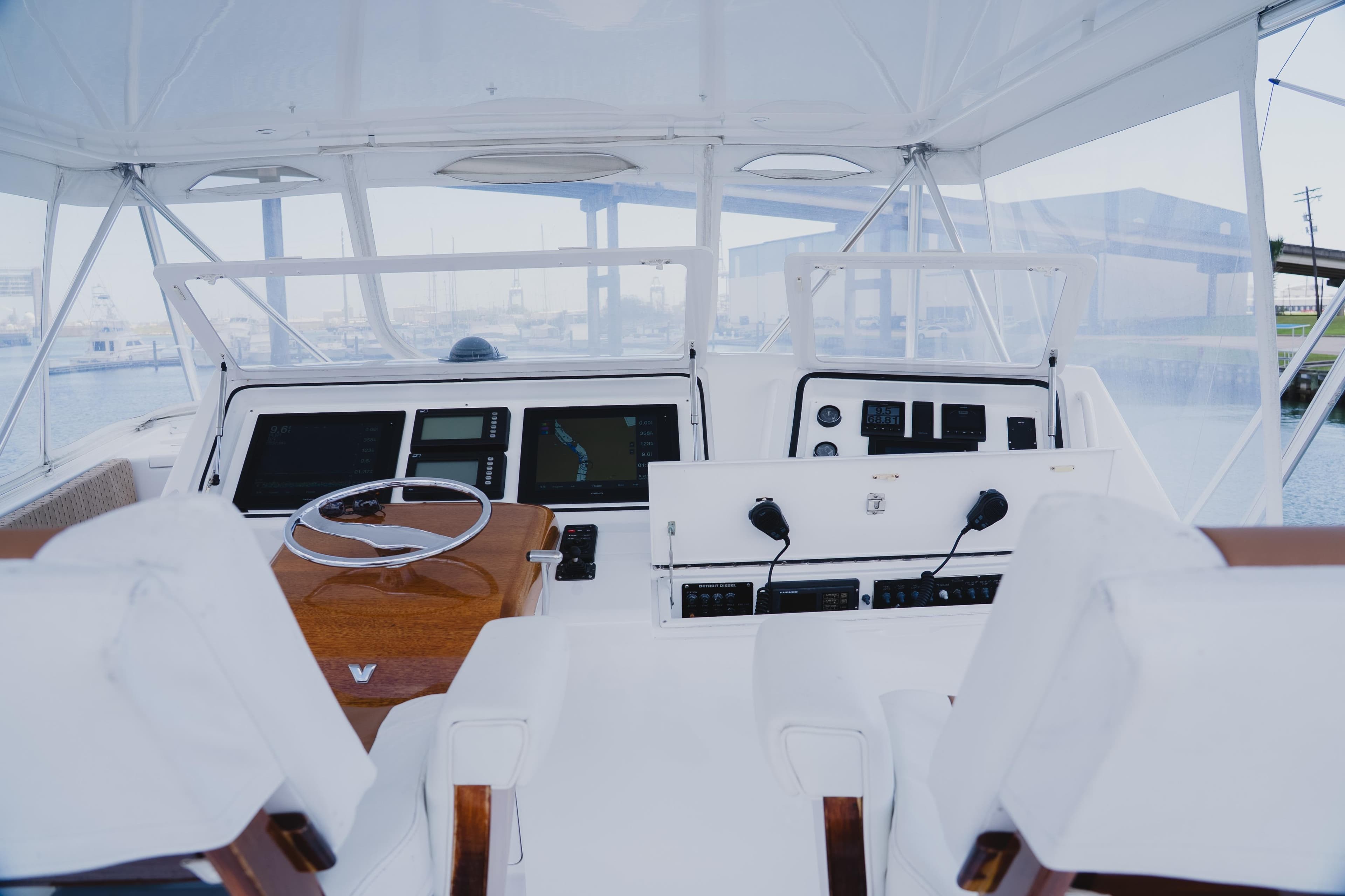 Interior view of a 1999 Viking 58 Convertible yacht cockpit with modern navigation equipment.