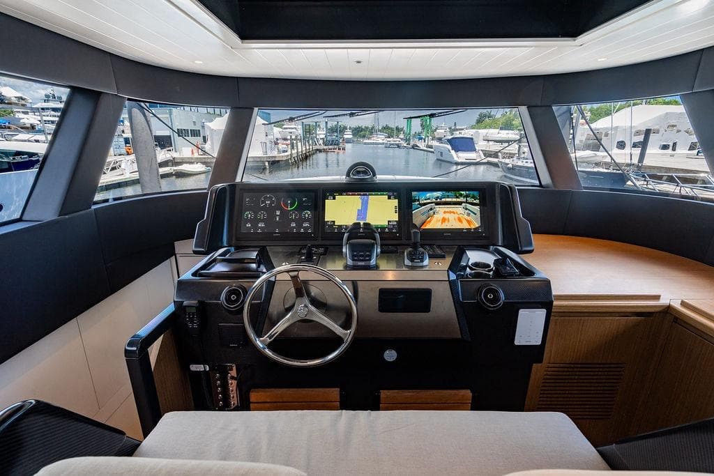 2023 Bluegame BG 72 yacht helm with advanced navigation displays and steering wheel.