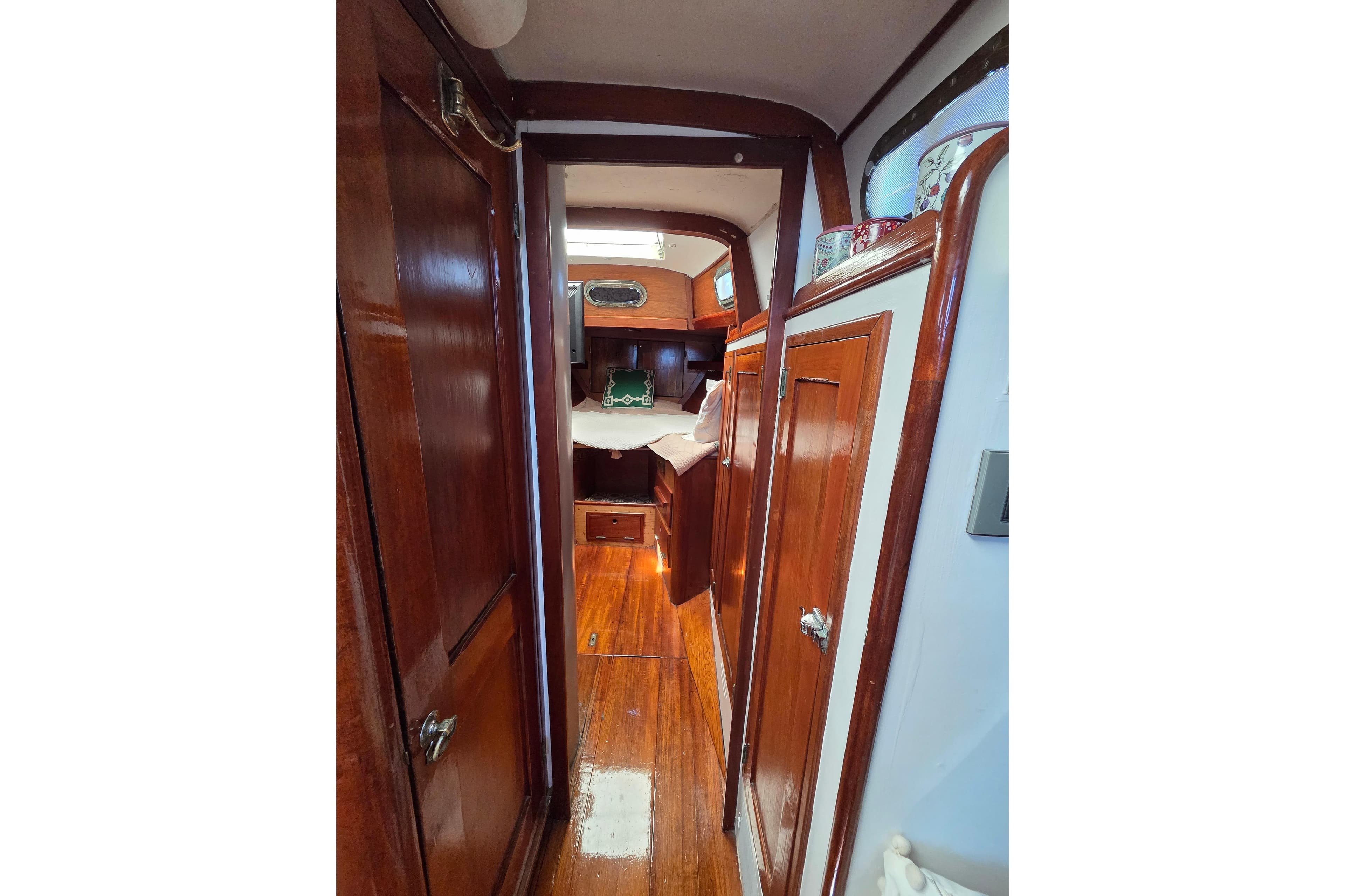 Interior of 1961 Hinckley Bermuda 40 sailboat with polished wood finish and cozy cabin.