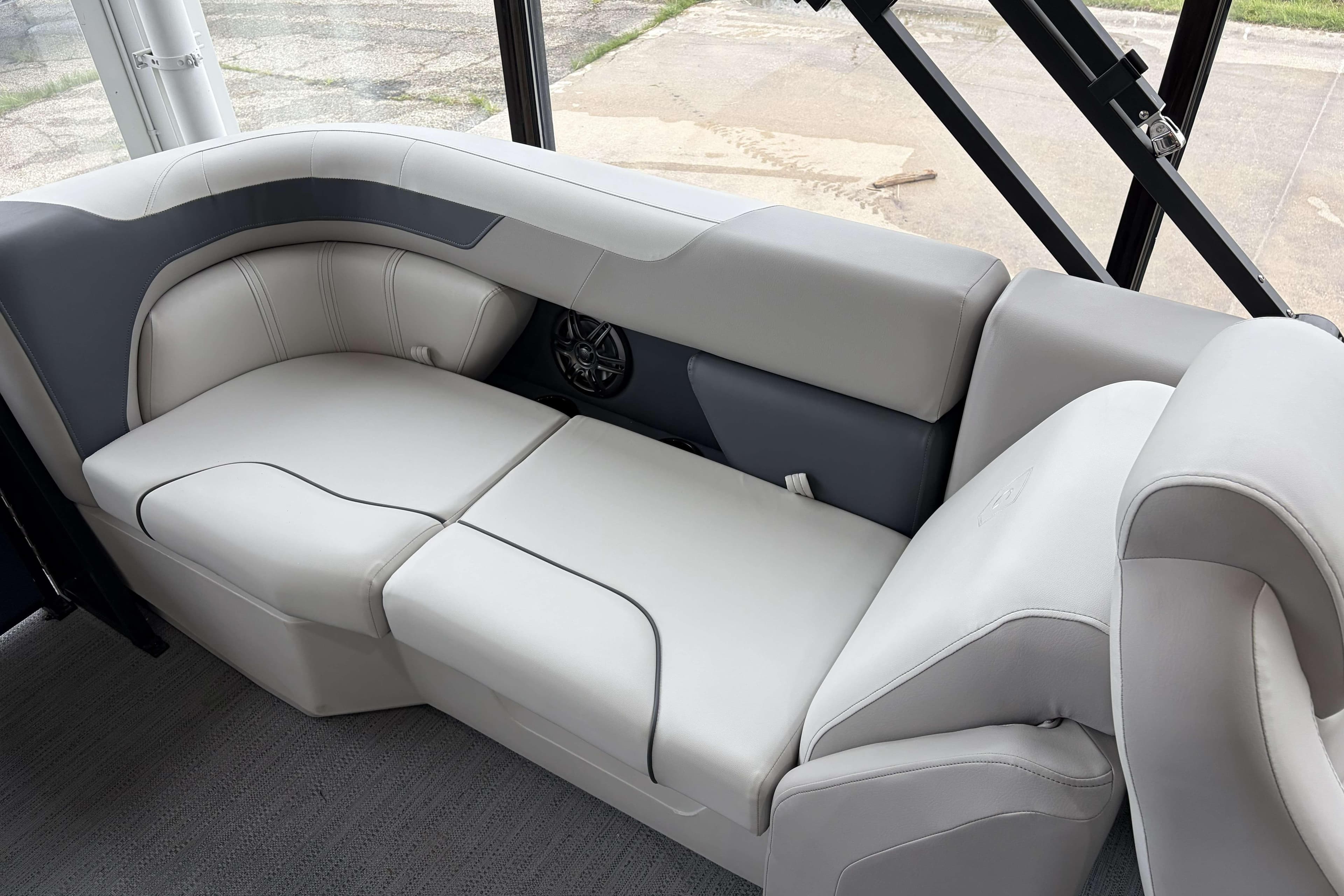Luxurious seating on 2026 Godfrey Sweetwater 2286 SB pontoon boat, featuring plush gray upholstery.