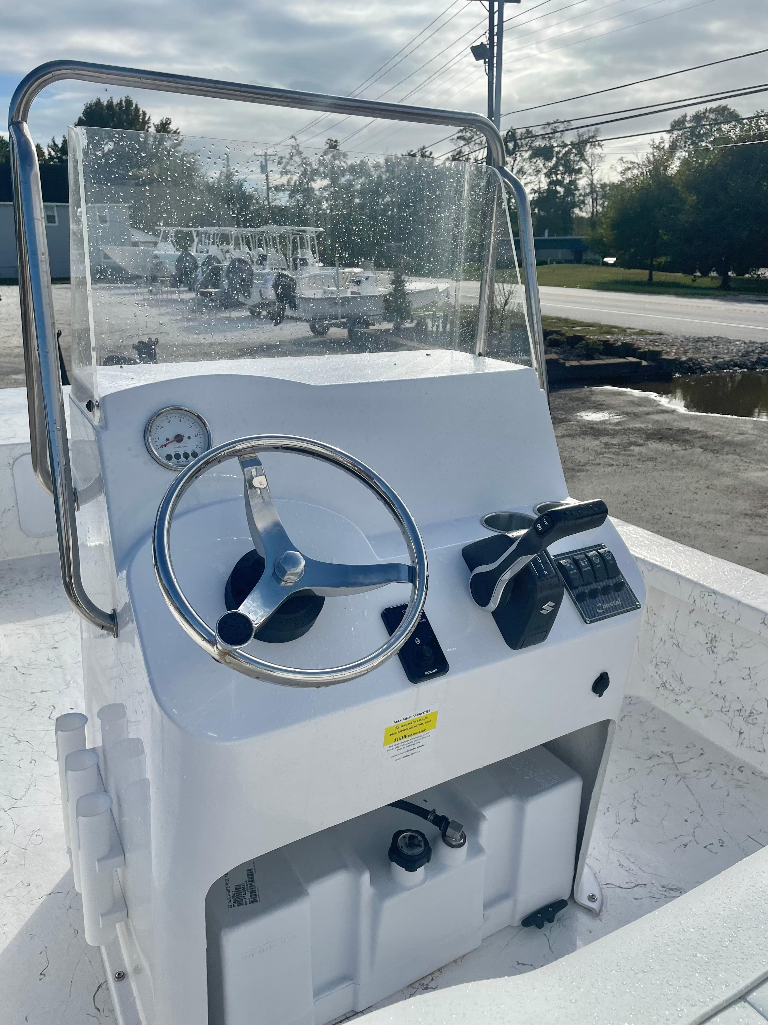 2025 Coastal Skiff 212 boat console with steering wheel and controls.