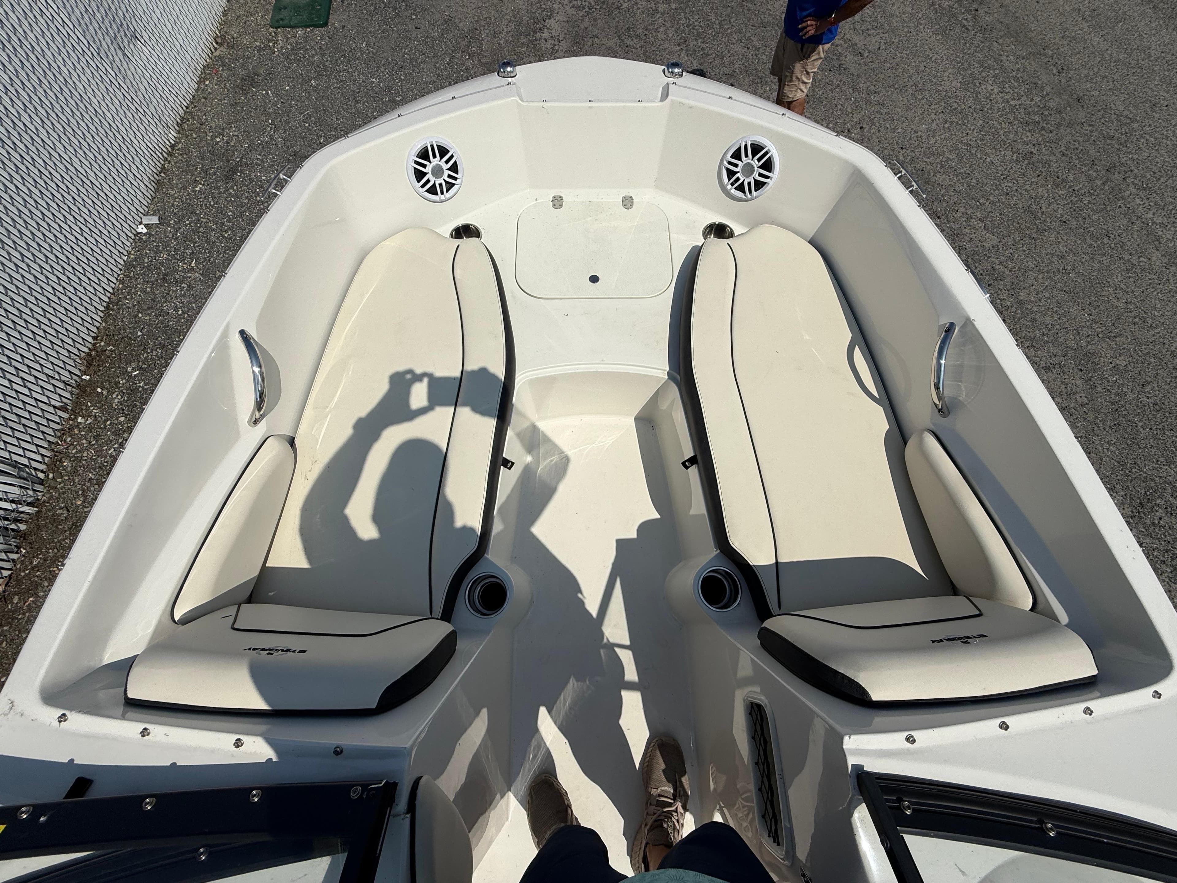 2023 Stingray 191 DC boat interior with white seating and cup holders.