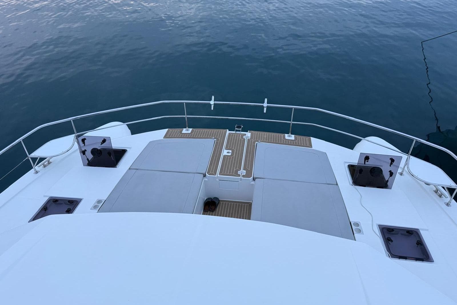 2023 Leopard 53PC yacht deck with cushioned seating and ocean view.