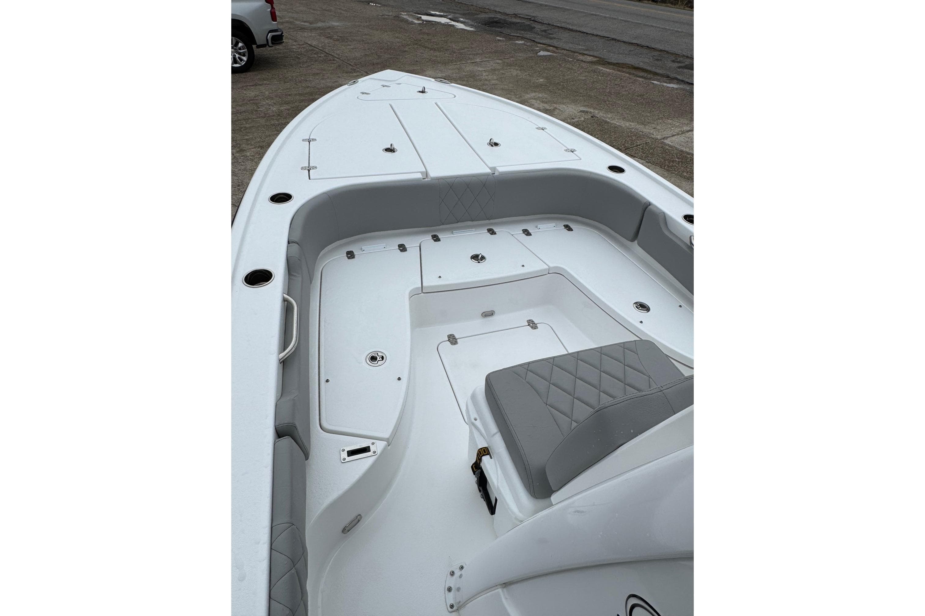 2026 Blazer Bay 2440 boat interior with seating and storage compartments.