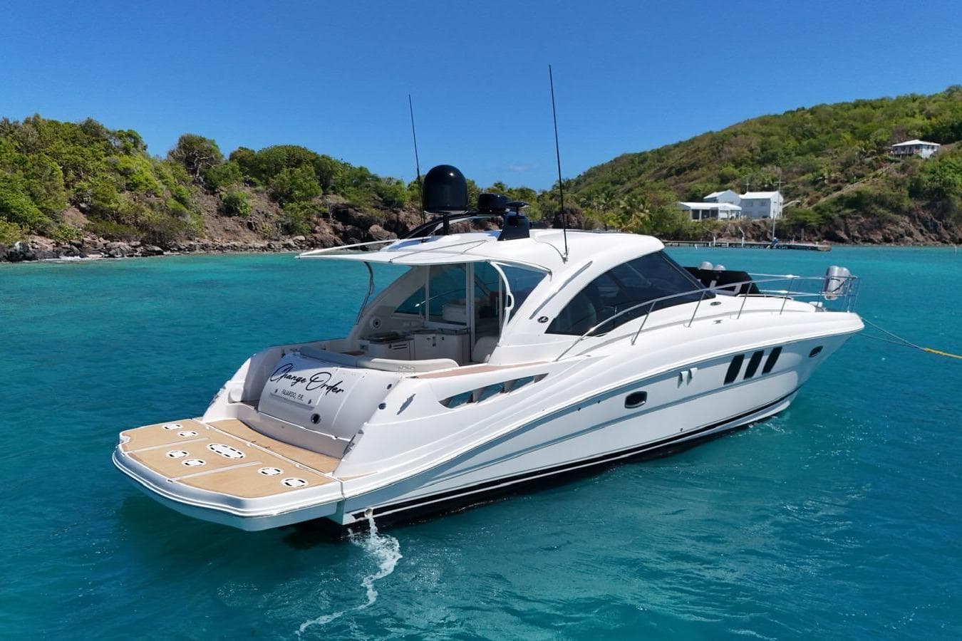 2006 Sea Ray 480 Sundancer yacht anchored in clear blue tropical waters.