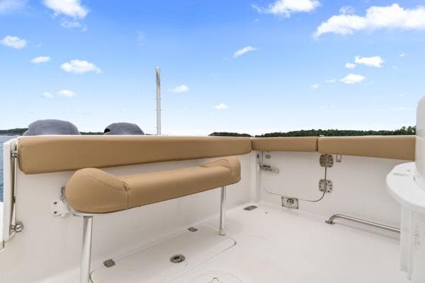 2018 Sea Hunt Gamefish 27 boat interior with tan seating under a clear blue sky.