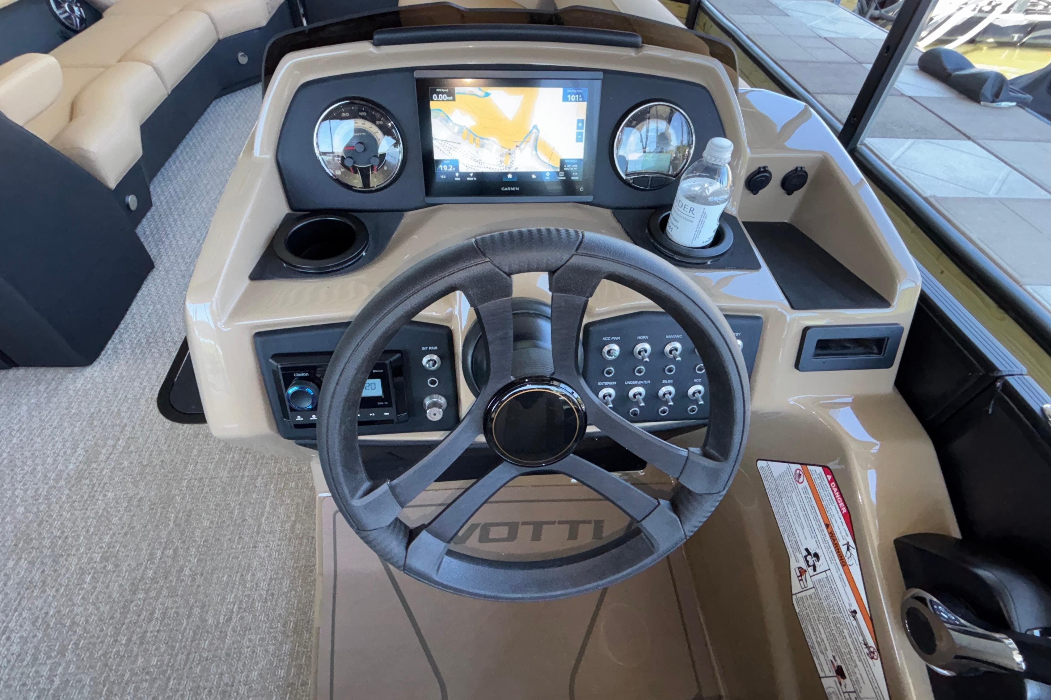 Cockpit of 2026 Evotti 525QL boat with steering wheel and navigation display.