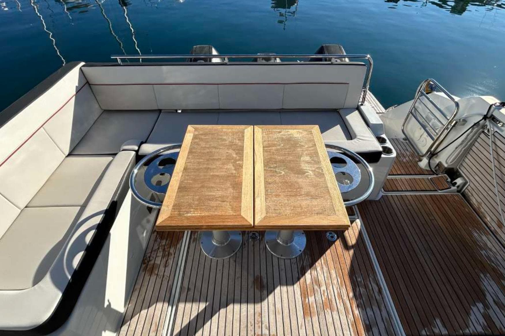2021 Jeanneau Cap Camarat 12.5 WA boat interior with wooden table and seating.