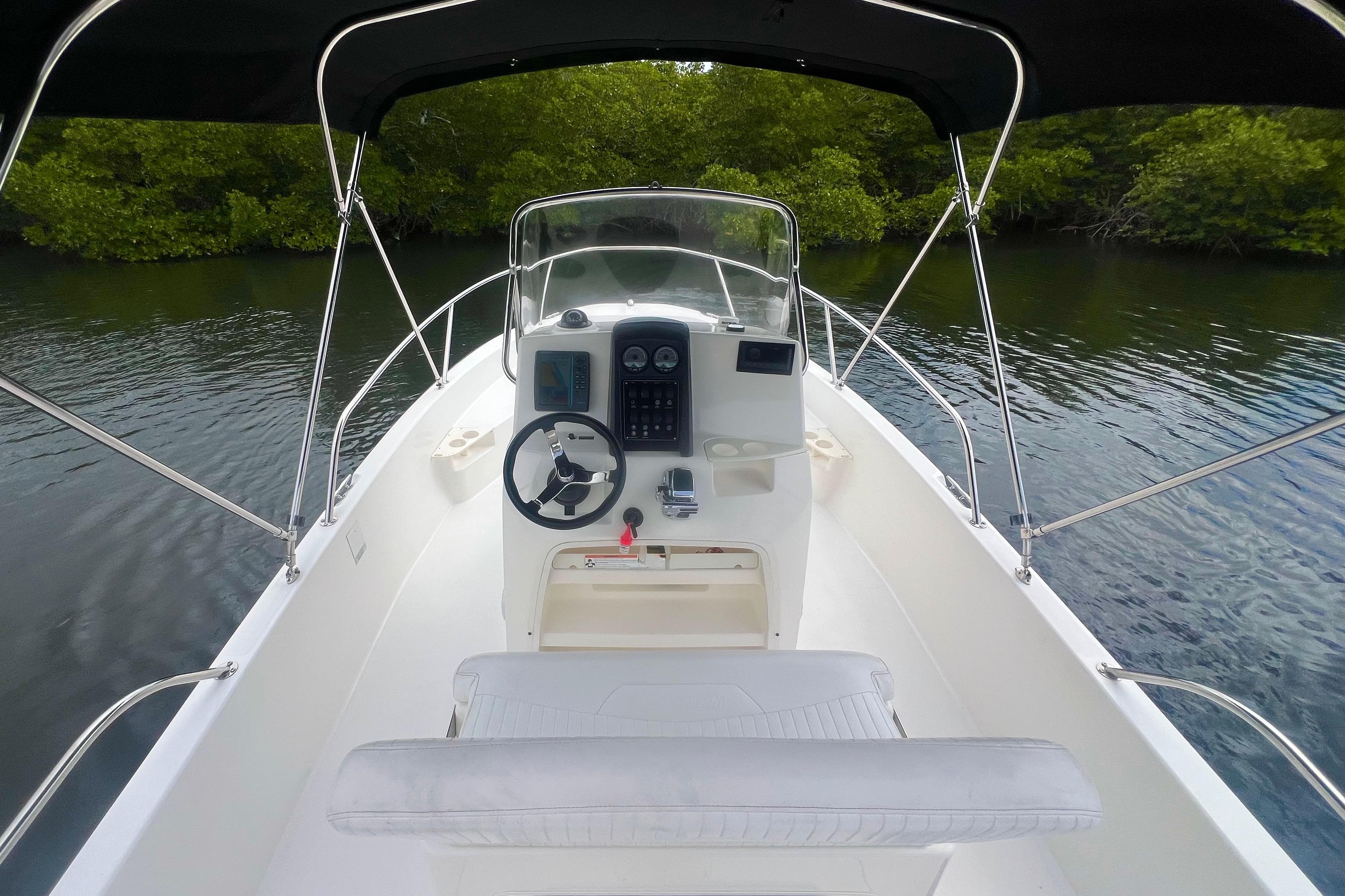 2008 Boston Whaler 200 Dauntless boat interior with steering console, surrounded by calm water.