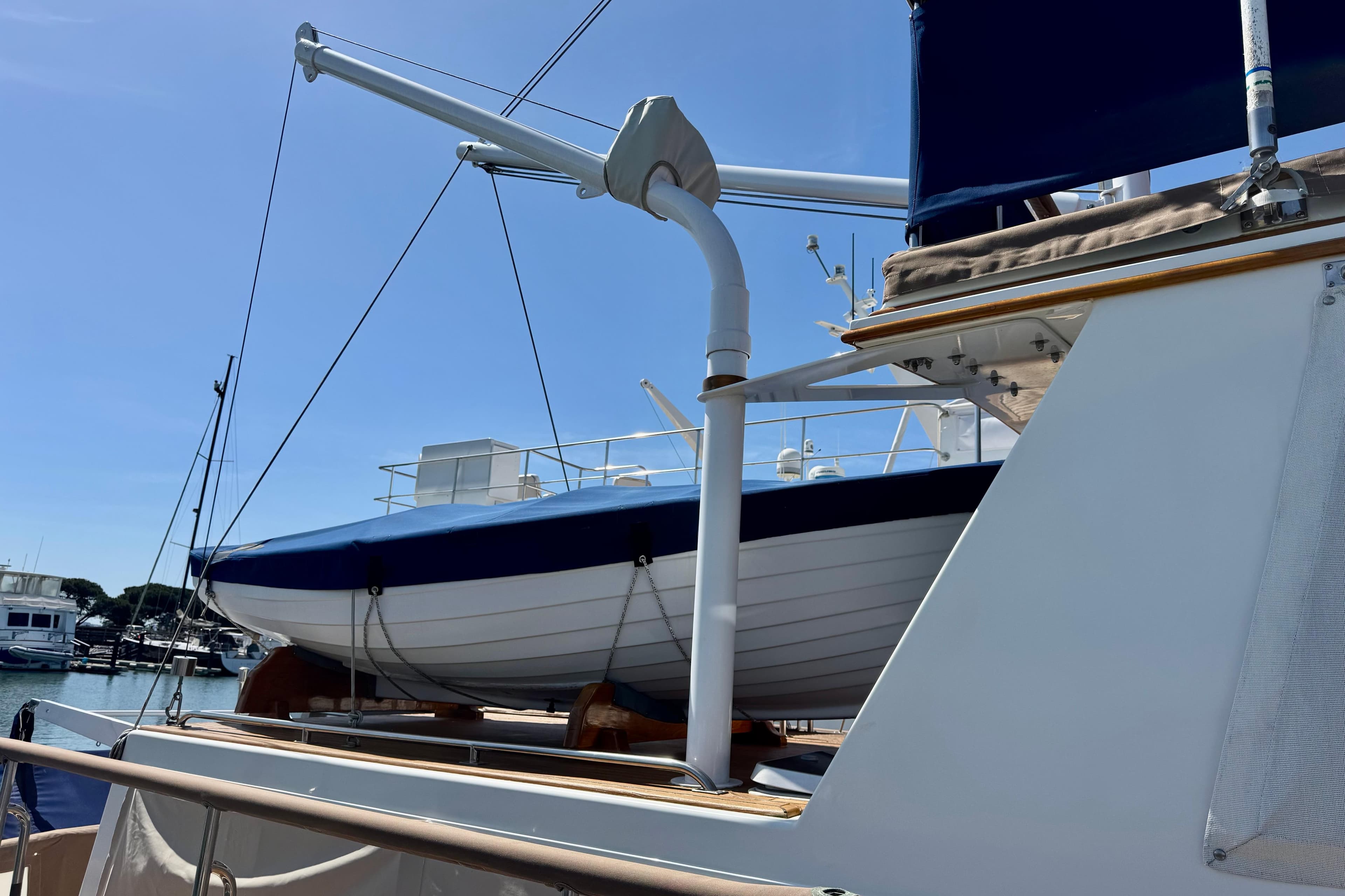 Grand Banks 46 Heritage CL yacht, 1996 model, with a lifeboat on deck under clear skies.