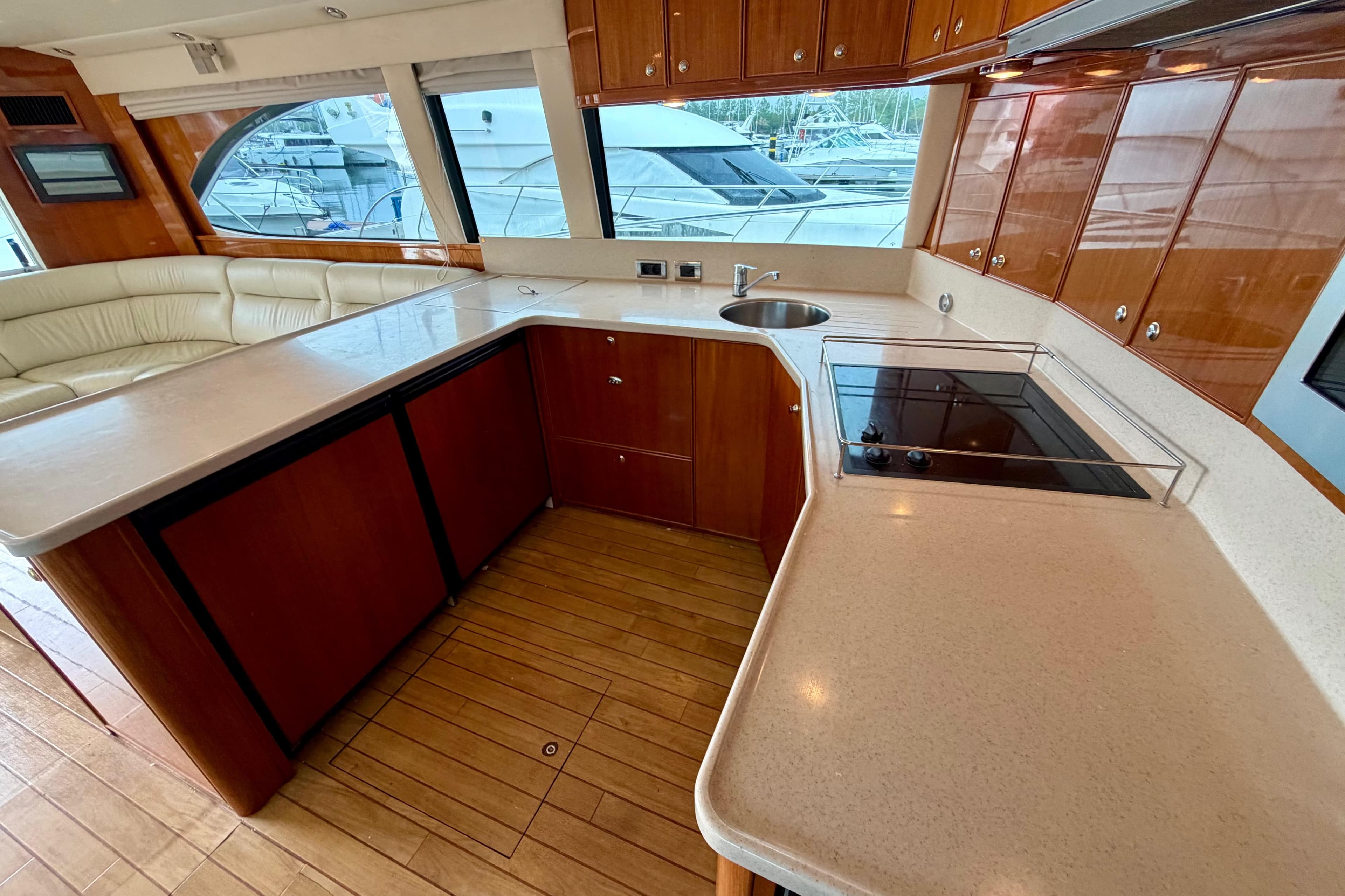 Luxurious kitchen interior of 2003 Riviera 60 Flybridge yacht with modern amenities.
