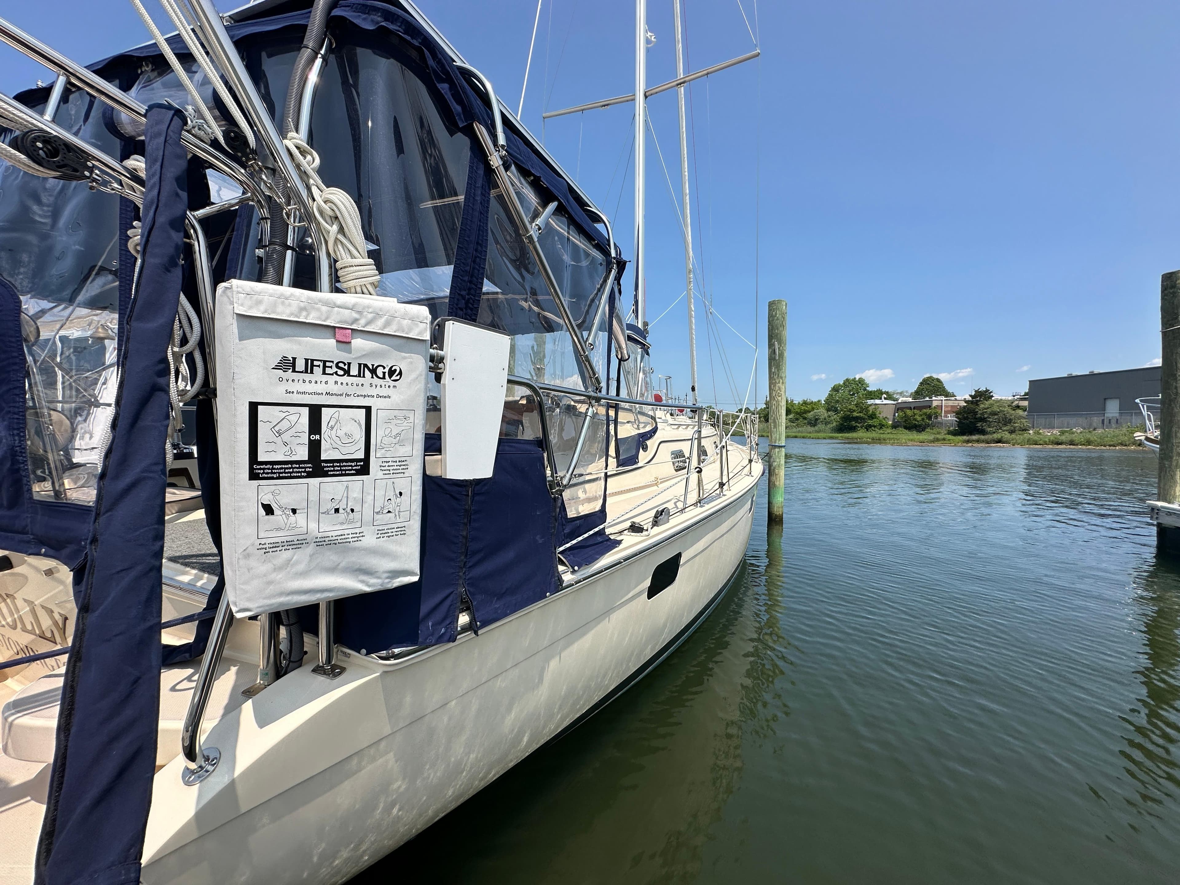 Sailboat Island Packet 439, 2021 model, docked with Lifesling rescue system visible.