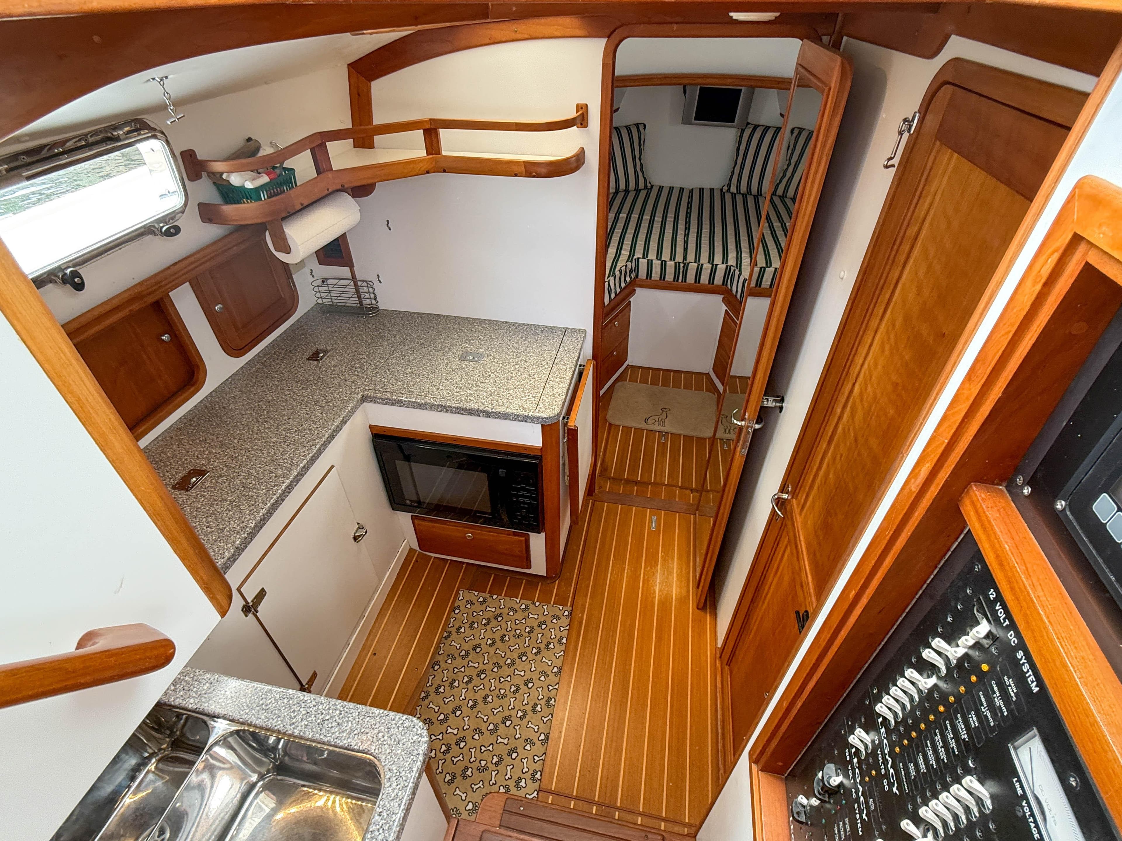 Interior of 2002 Legacy 34 Express boat with kitchen and sleeping area.
