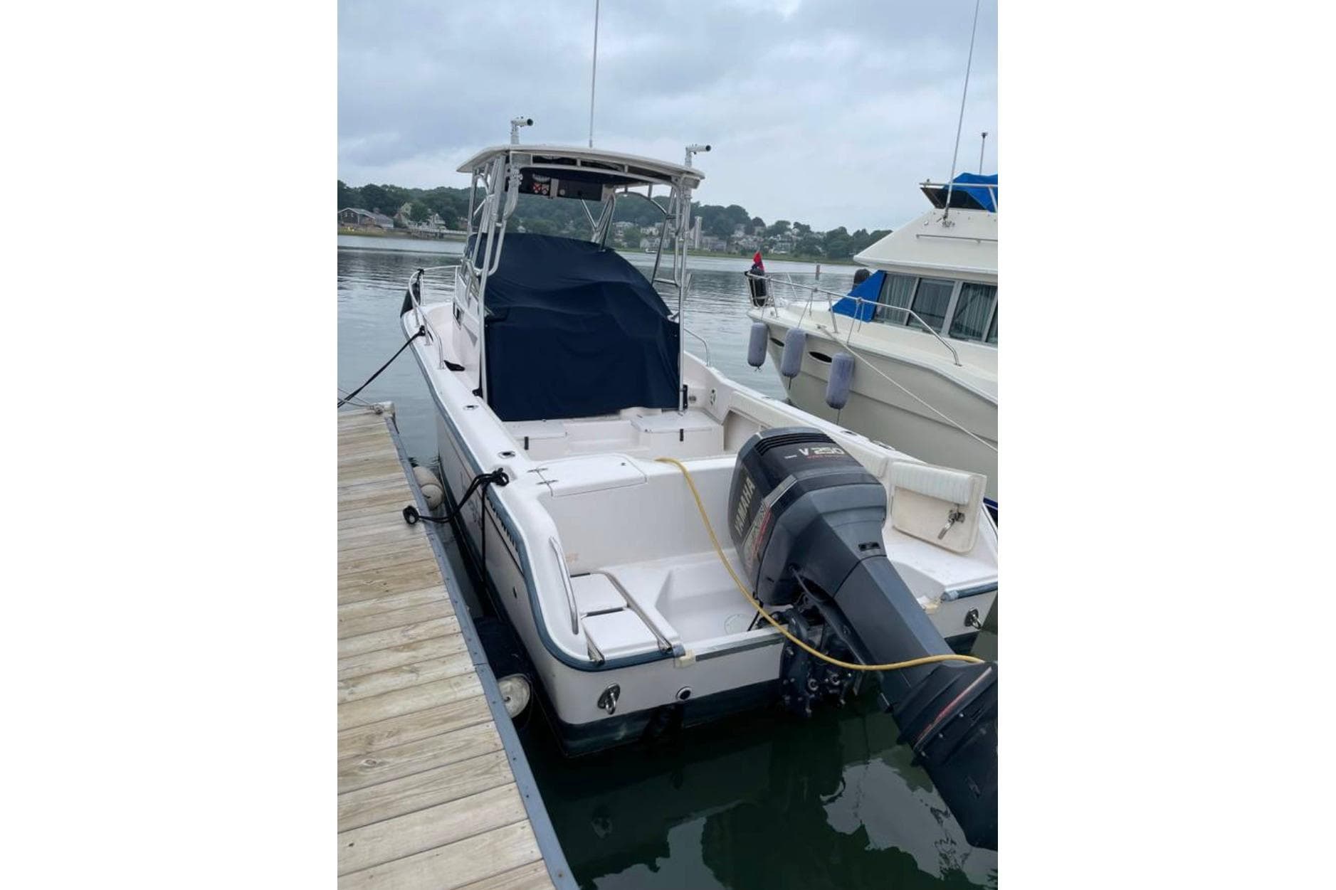 2001 Grady-White Islander 268 boat docked, featuring outboard motor and covered seating area.