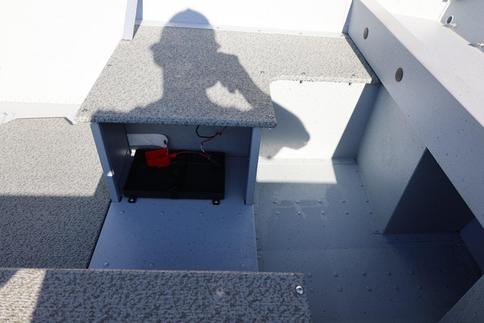2026 Lund SSV-16 Tiller boat interior with storage compartment and shadow.
