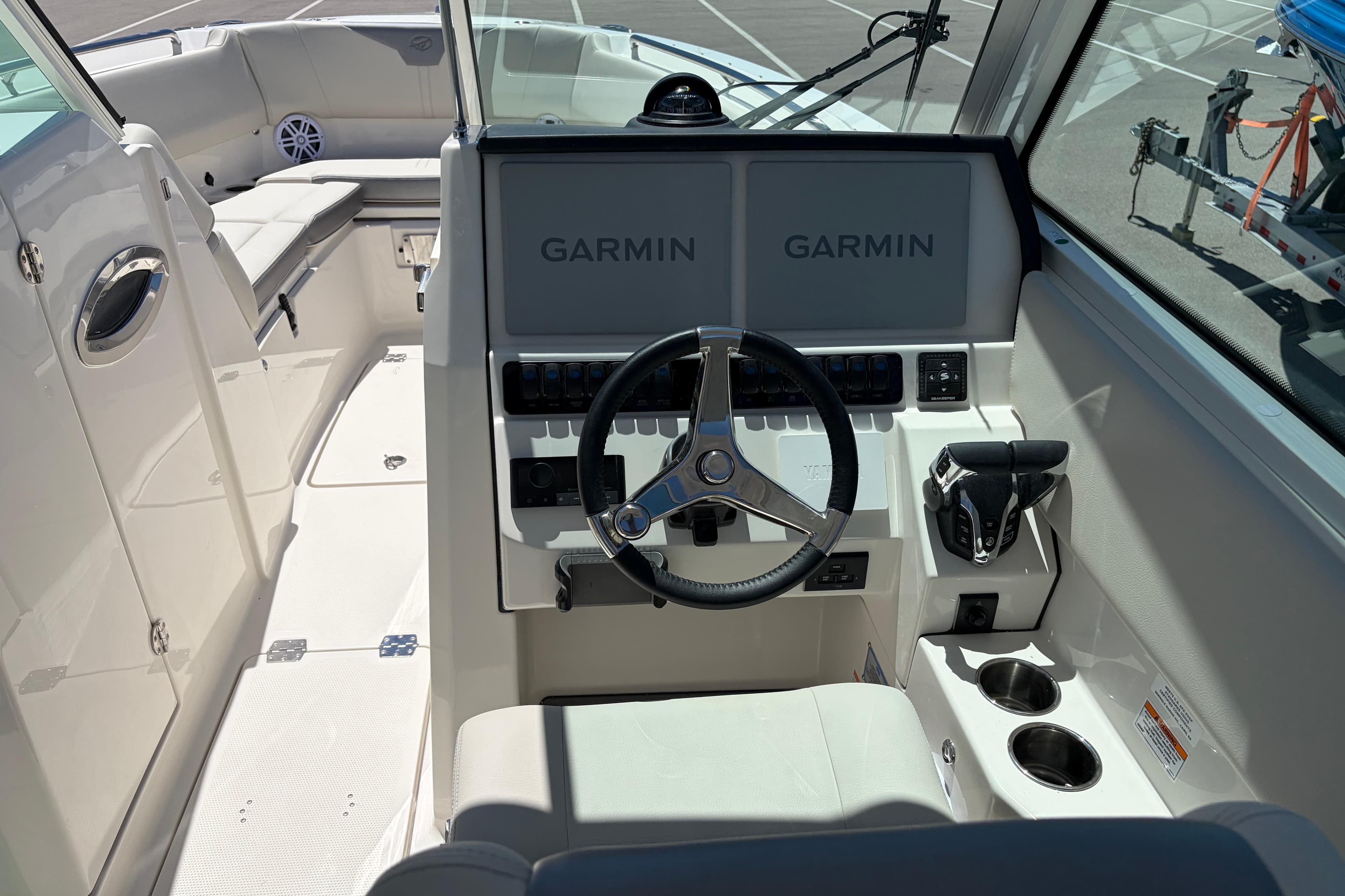 2026 Sailfish 276 DC boat cockpit with Garmin displays and steering wheel.