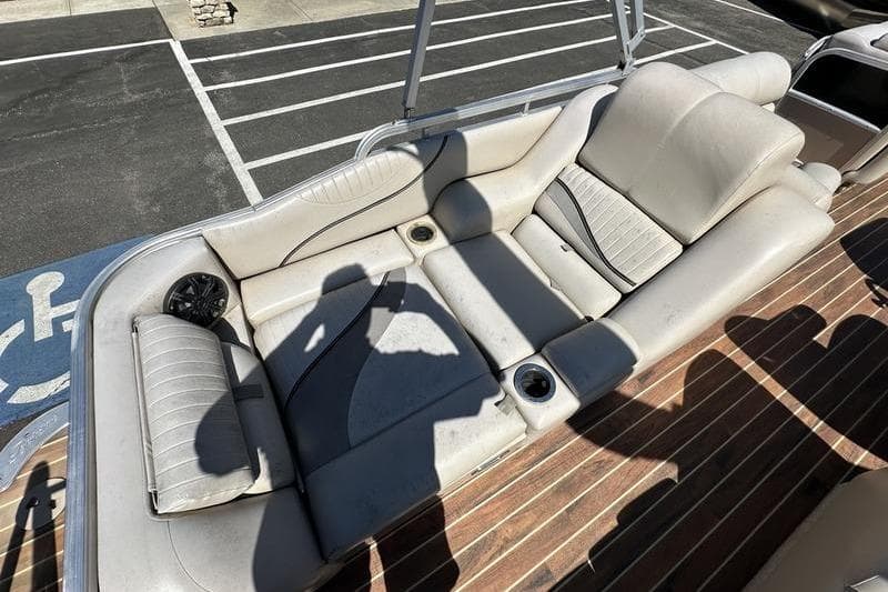 2011 Berkshire 243 SLX boat interior with beige seating and wood flooring.