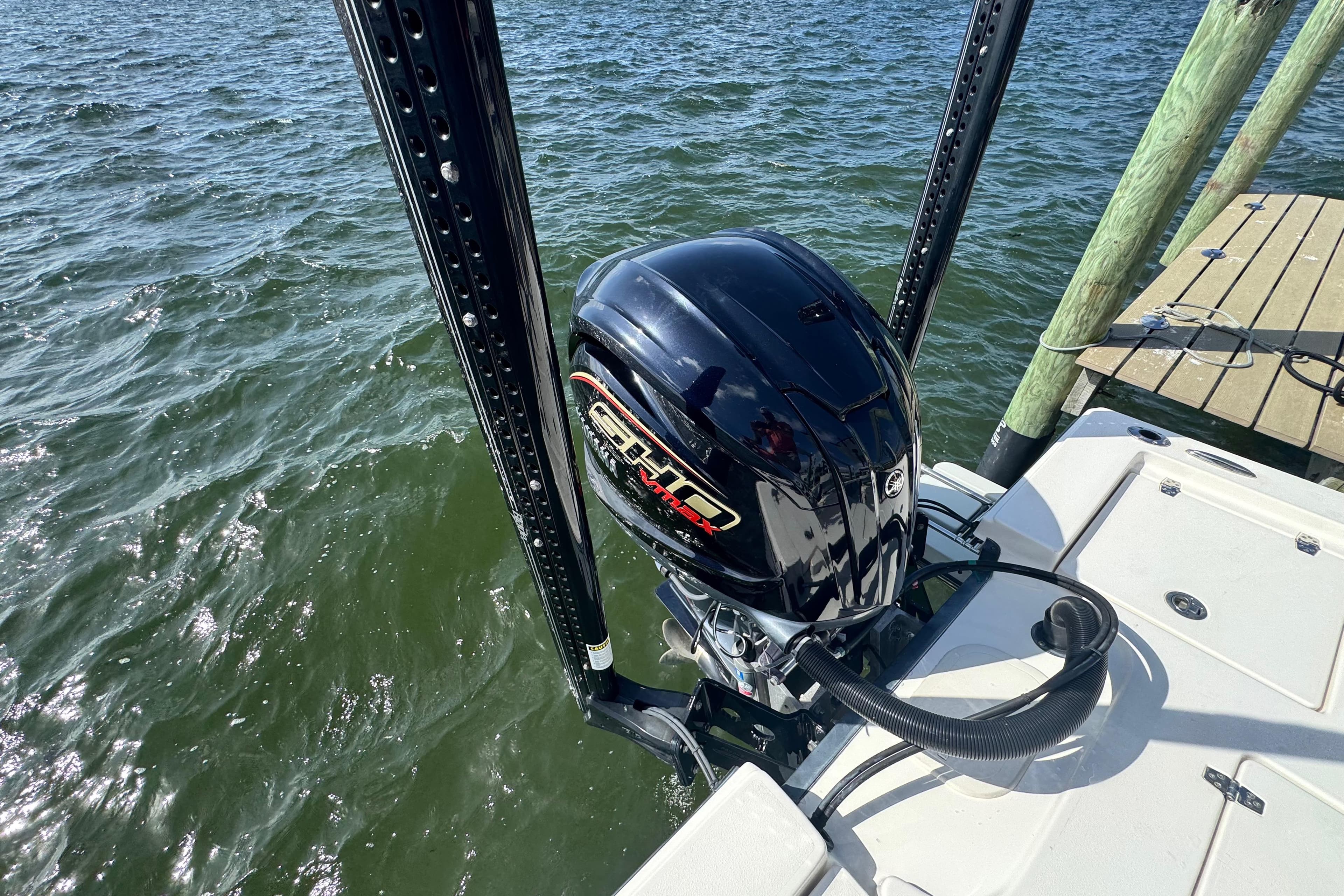 2022 Pathfinder 2400 TRS boat engine on water near dock.