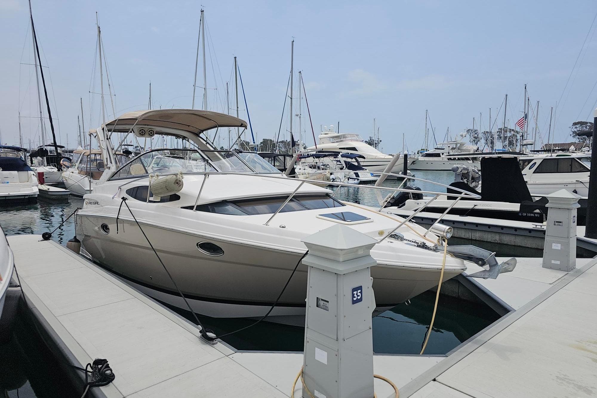 2009 Regal 2860 Window Express docked at a marina with other boats.
