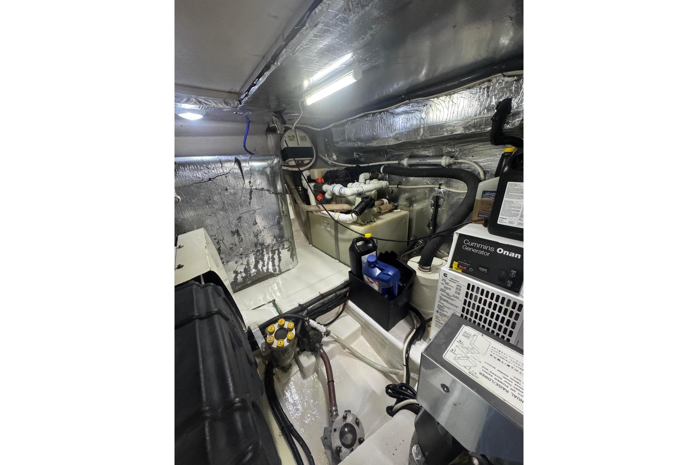 Engine room of 2004 Riviera 51 Flybridge with Cummins Onan generator and insulated walls.