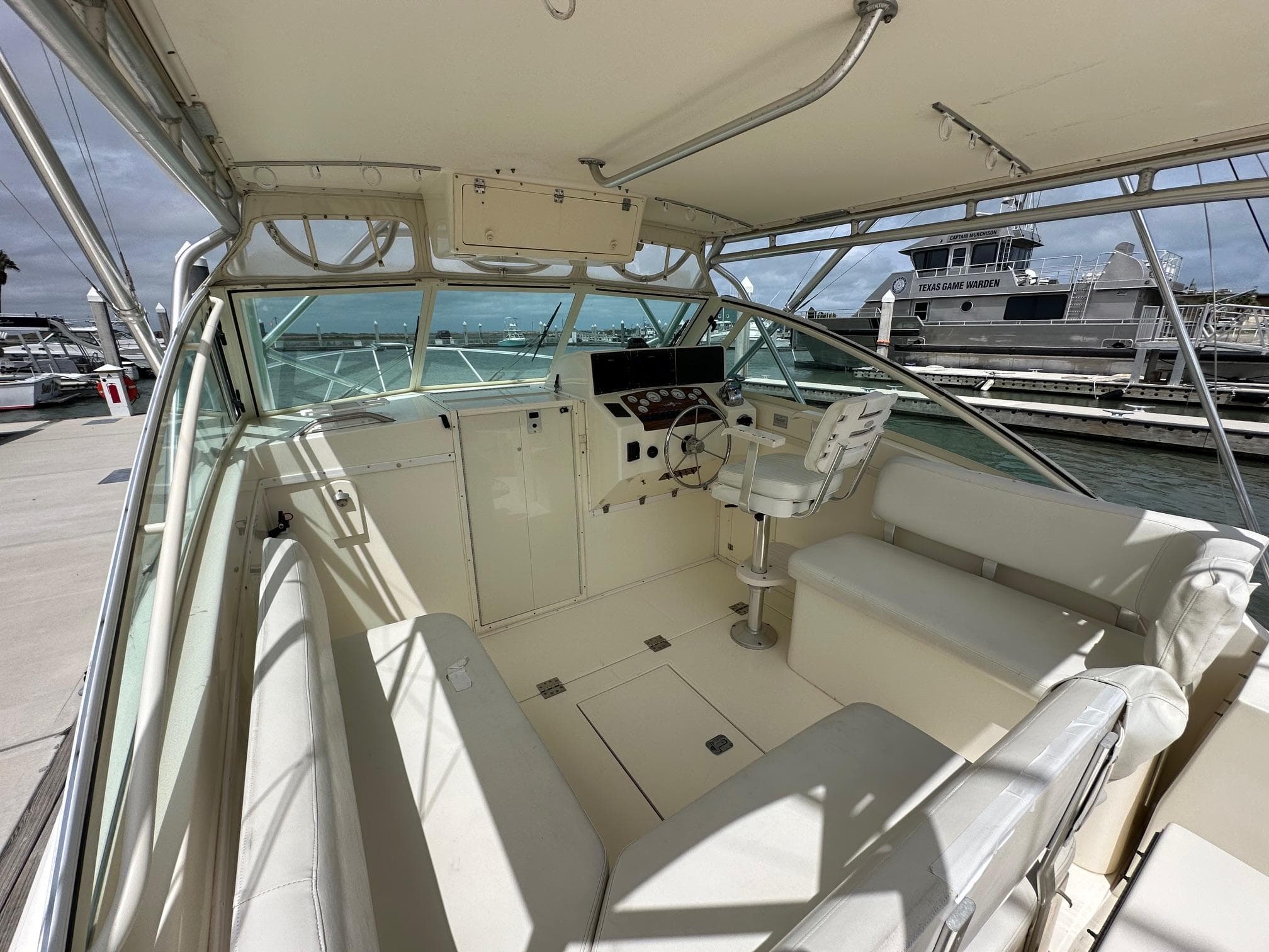 2006 Albemarle 320 Express Fisherman boat interior with helm station and seating.