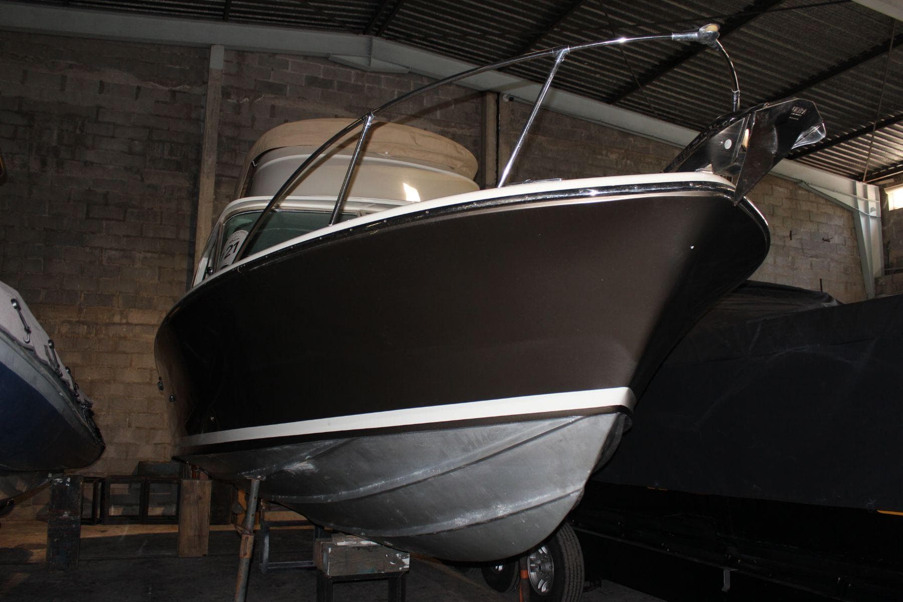 1974 Riva Bertram 25 Sportfisherman boat in a warehouse, side view.