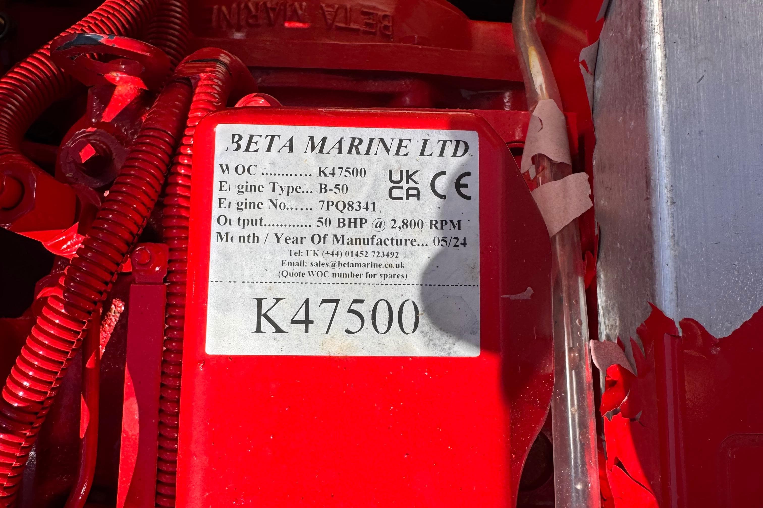Red Beta Marine engine label with specifications for a 1956 Prowler Norman Hodgdon 24.