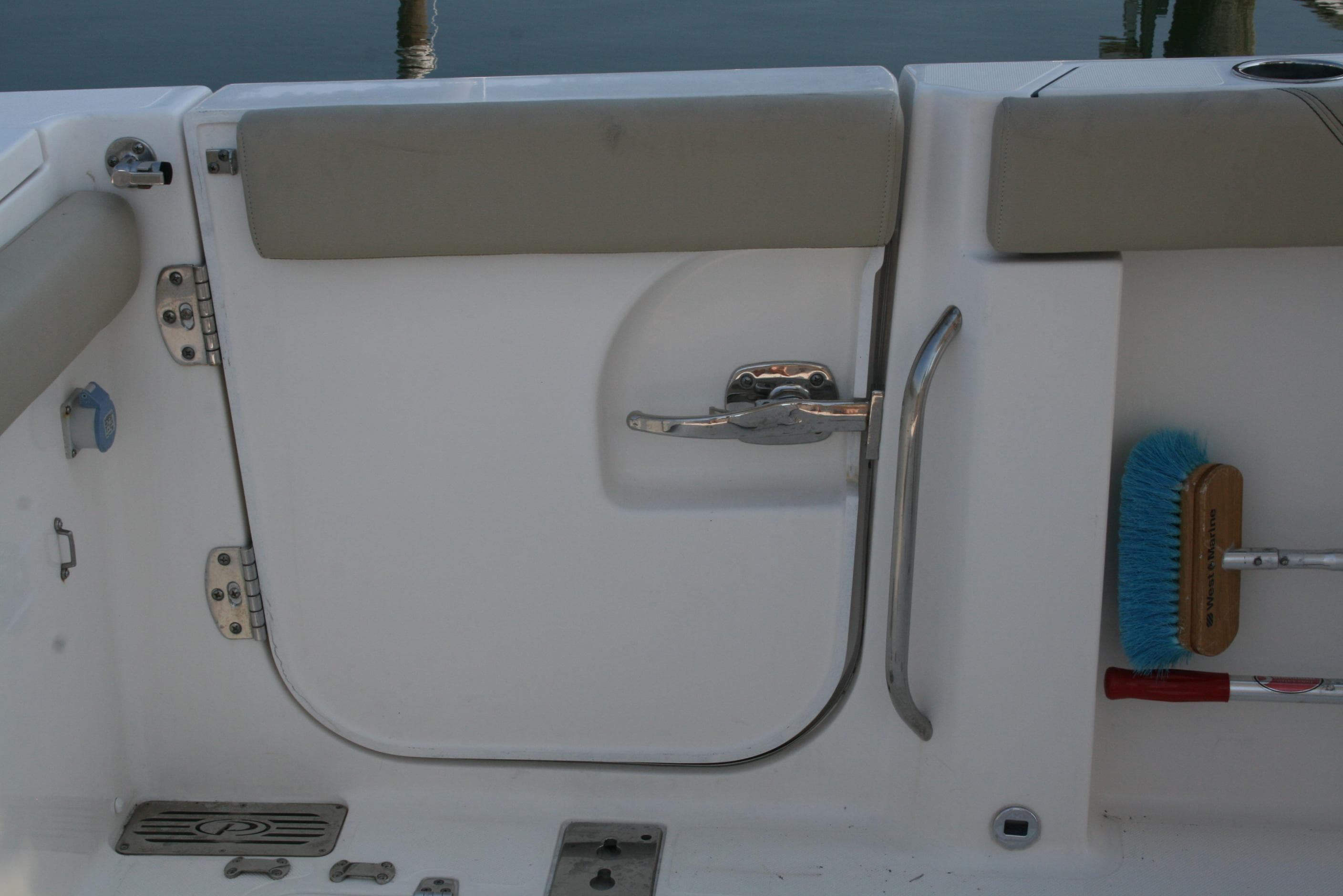 2018 Pursuit S 328 Sport boat interior with door and cleaning brush.