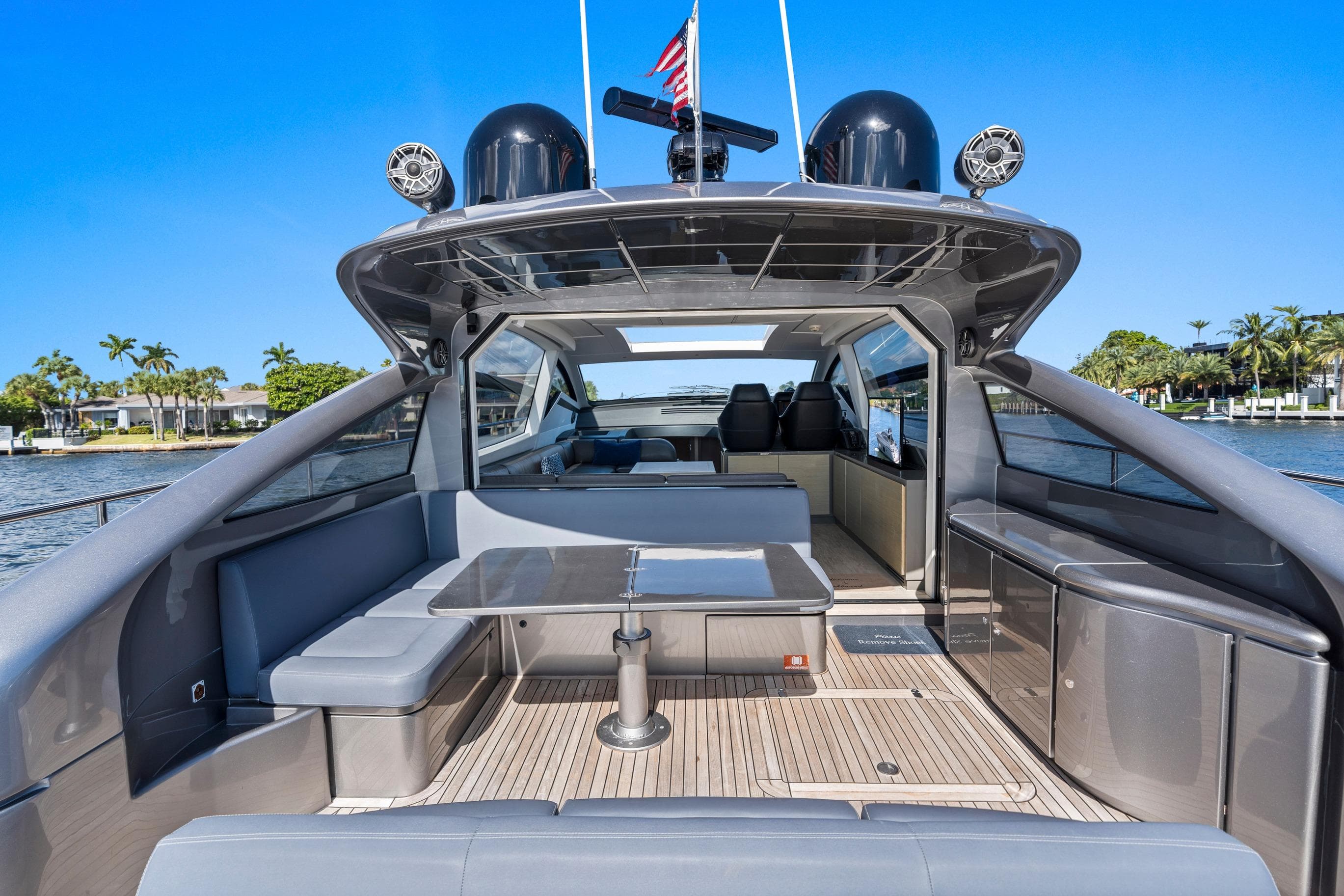 Luxurious 2016 Pershing 62' yacht with sleek design and spacious deck area.
