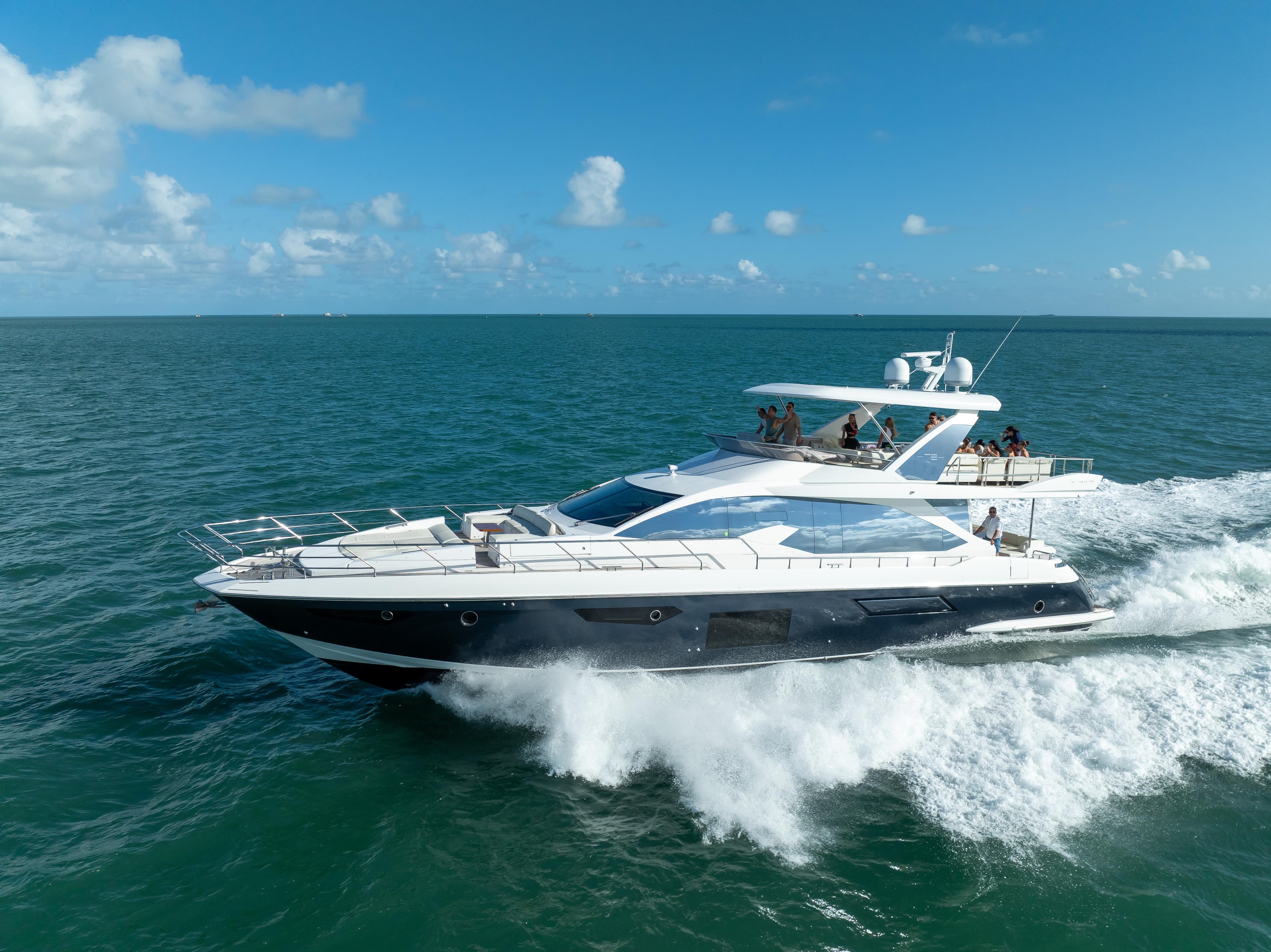 Azimut Fly 72 yacht cruising on open sea, 2016 model, under clear blue skies.
