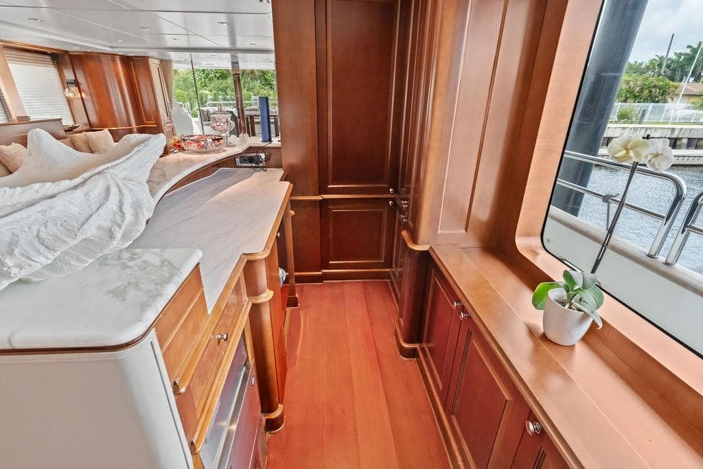 Luxurious 2008 Benetti Classic yacht interior with elegant wood paneling and large windows.