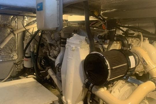 Engine room of a 2006 Meridian 411 Sedan yacht, showcasing mechanical components and systems.