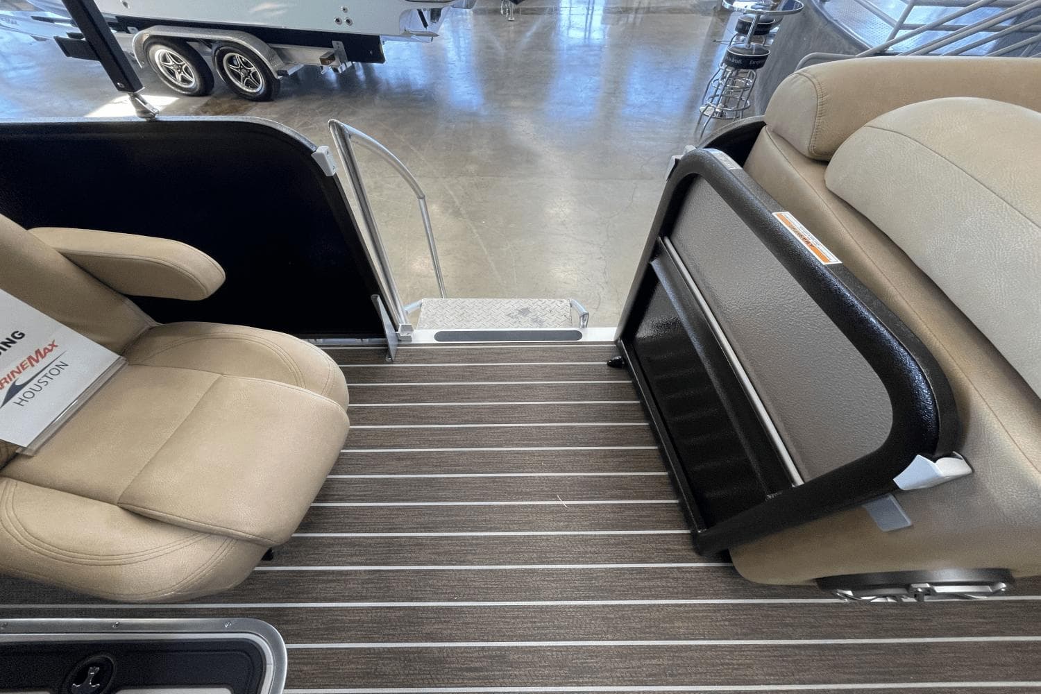 2023 Premier 250 Intrigue boat interior with beige seating and striped flooring.